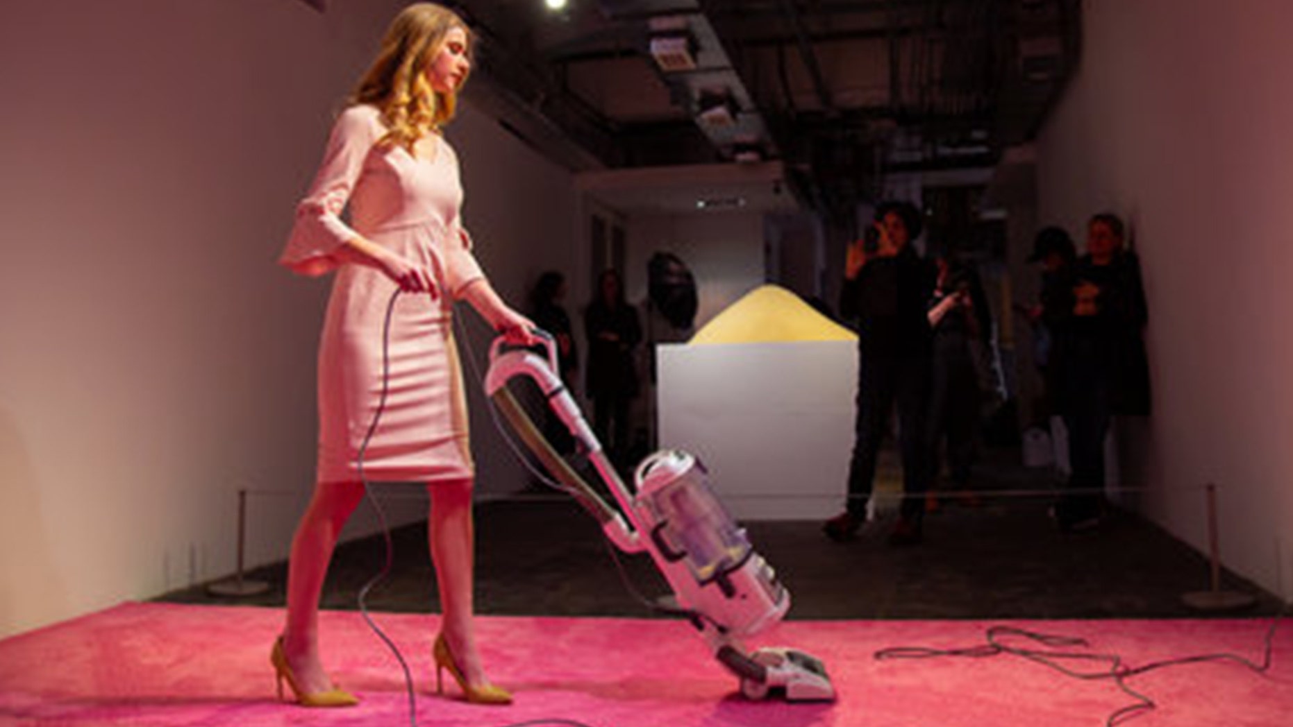 An Ivanka Trump look-alike vacuums at a recently launched art exhibit in Washington, D.C.