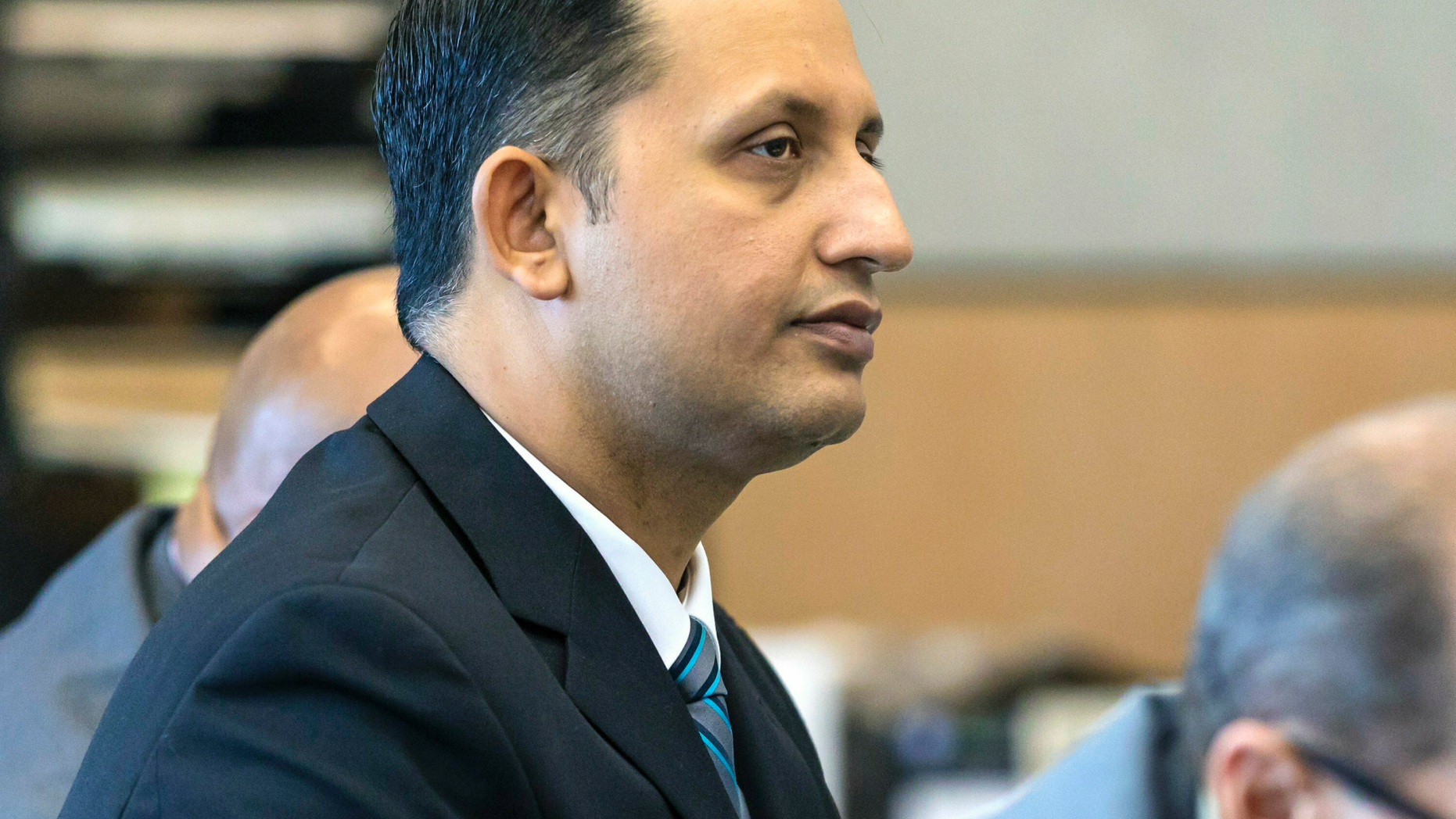 Former Palm Beach Gardens police officer Nouman Raja listens to defense attorney Scott Richardson give opening statements in Raja's trial, Tuesday, Feb. 26, 2019, in West Palm Beach, Fla. Raja is charged with the fatal 2015 shooting of a stranded black motorist, 31-year-old Corey Jones. (Lannis Waters/Palm Beach Post via AP, Pool)