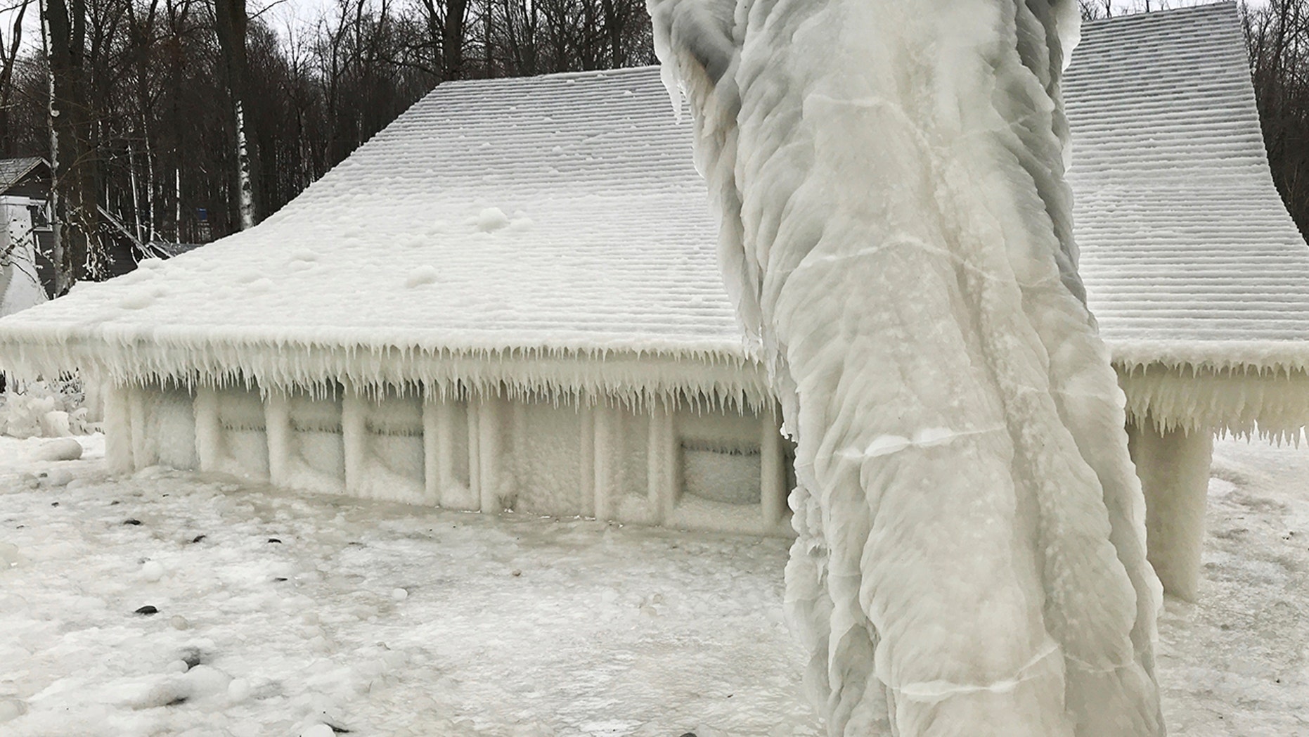 A house is covered in ice near the edge of Lake Ontario in Pulaski, N.Y., on Wednesday, Feb. 27, 2019. Starting over the weekend, wind gusts of up to 70 mph caused freezing spray from the lake to wrap nearby summer homes in ice as high winds howled through much of the eastern U.S. [Natalie Kucko via AP)