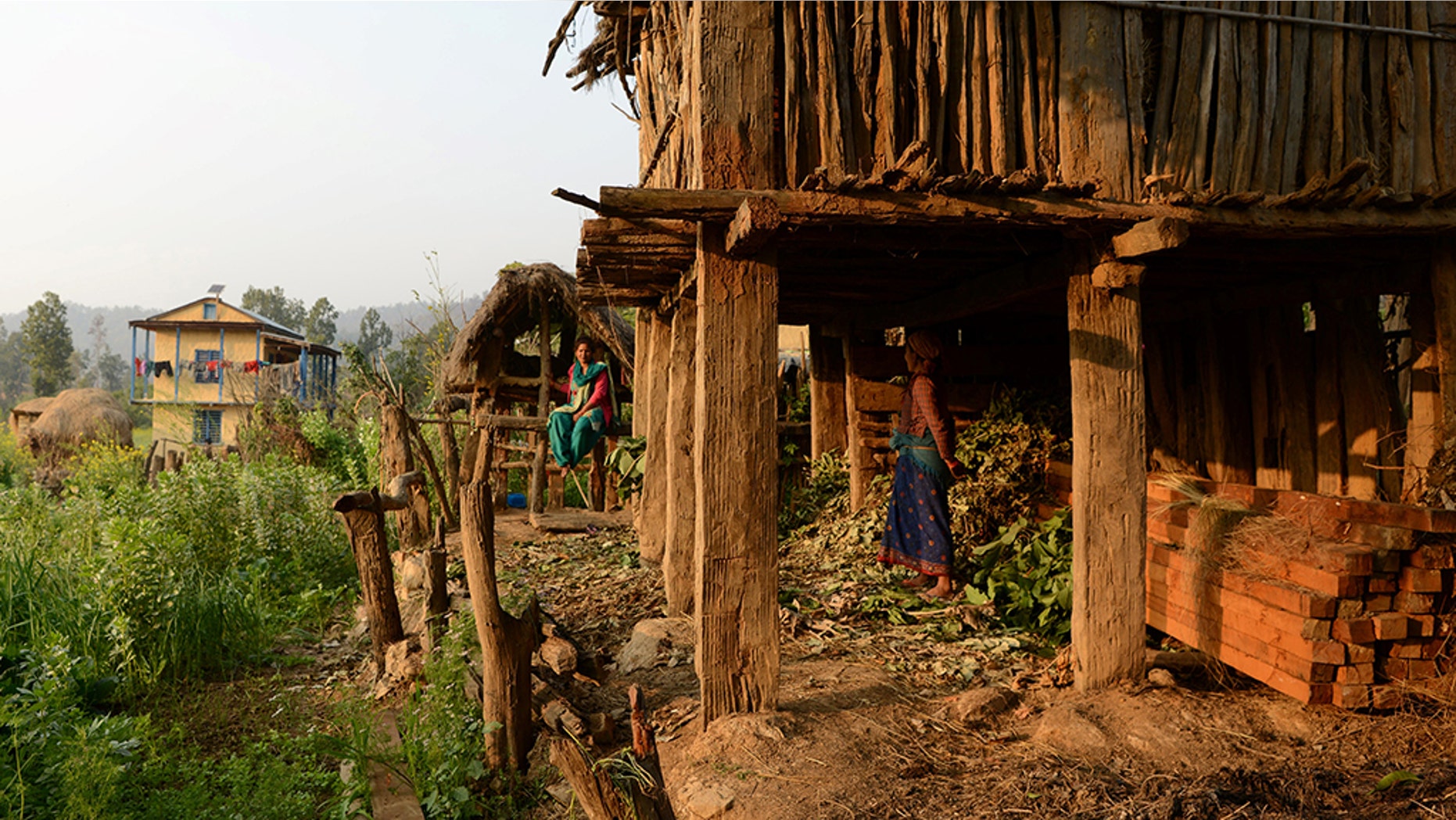In this photograph taken on February 3, 2017, Nepalese woman Yum Kumari Giri looks at a Chhaupadi hut during her menstruation period in Surkhet District, some 520km west of Kathmandu.