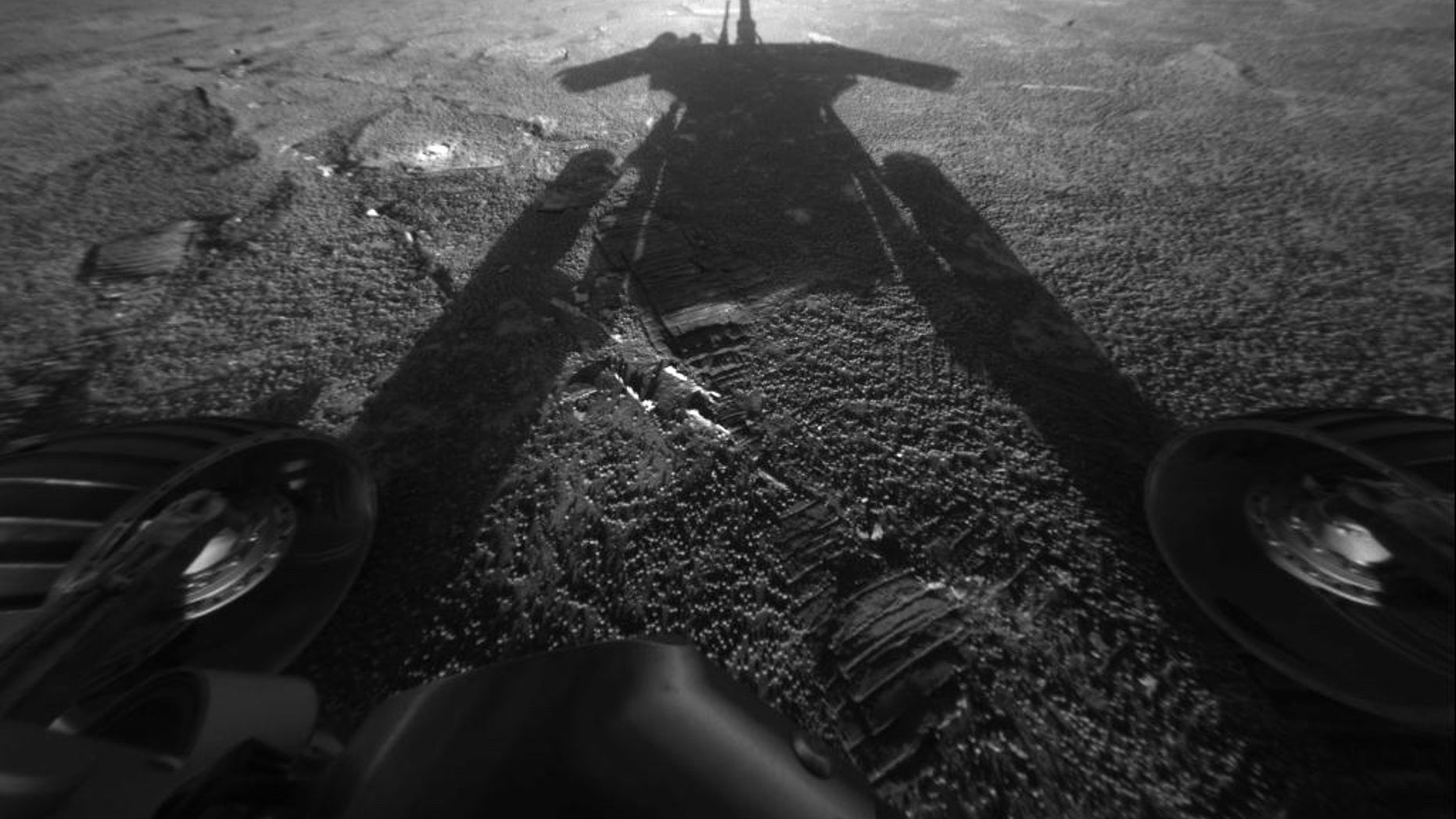 NASA's Mars rover Opportunity reveals its shadow, seen on July 26, 2004, and snapped by the rover’s front hazard-avoidance camera. At the time, Opportunity was moving farther into Endurance Crater in the Meridiani Planum region of Mars.