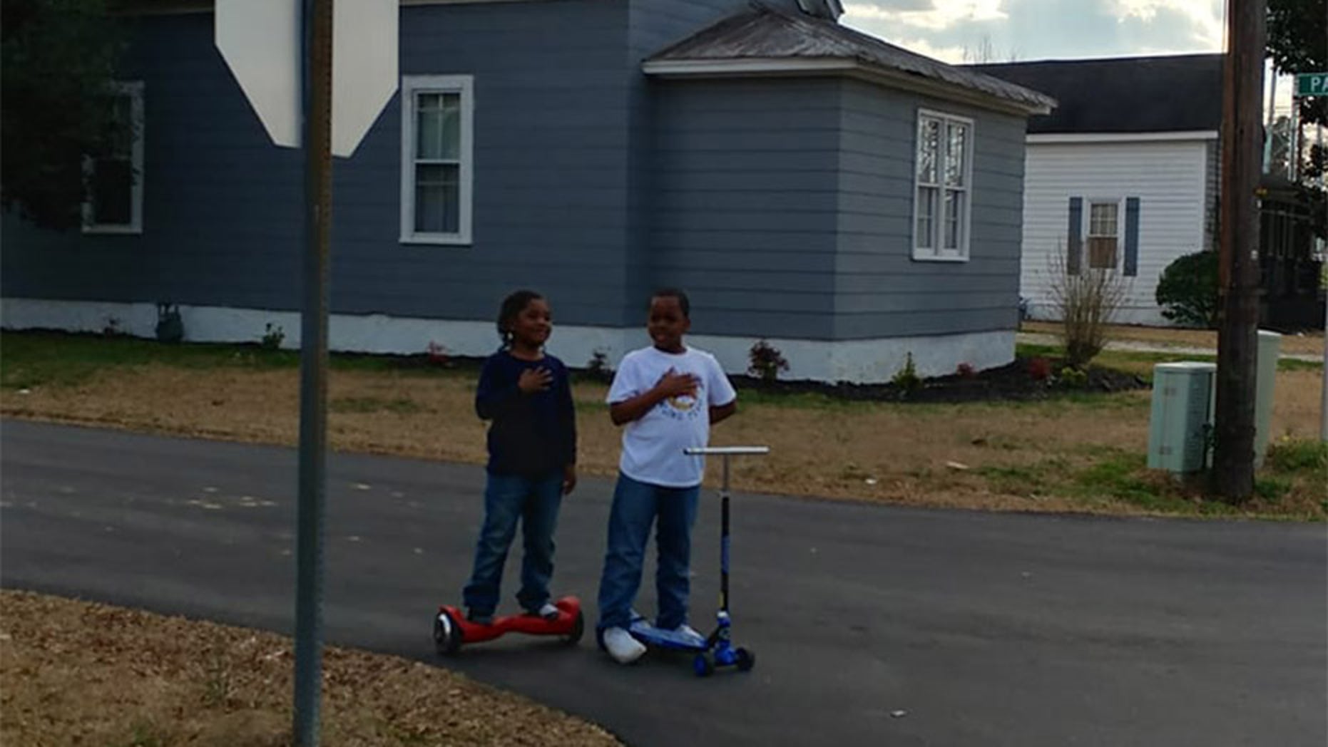 Two boys are being praised after this photo was taken of them saying the pledge of allegiance.