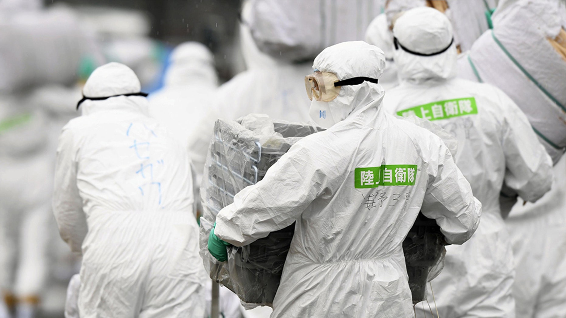 Members of the Japan Self-Defense Forces (JSDF) undergo a quarantine operation at a hog farm after an outbreak of swine fever was detected, in Toyota, Aichi Prefecture, Japan.