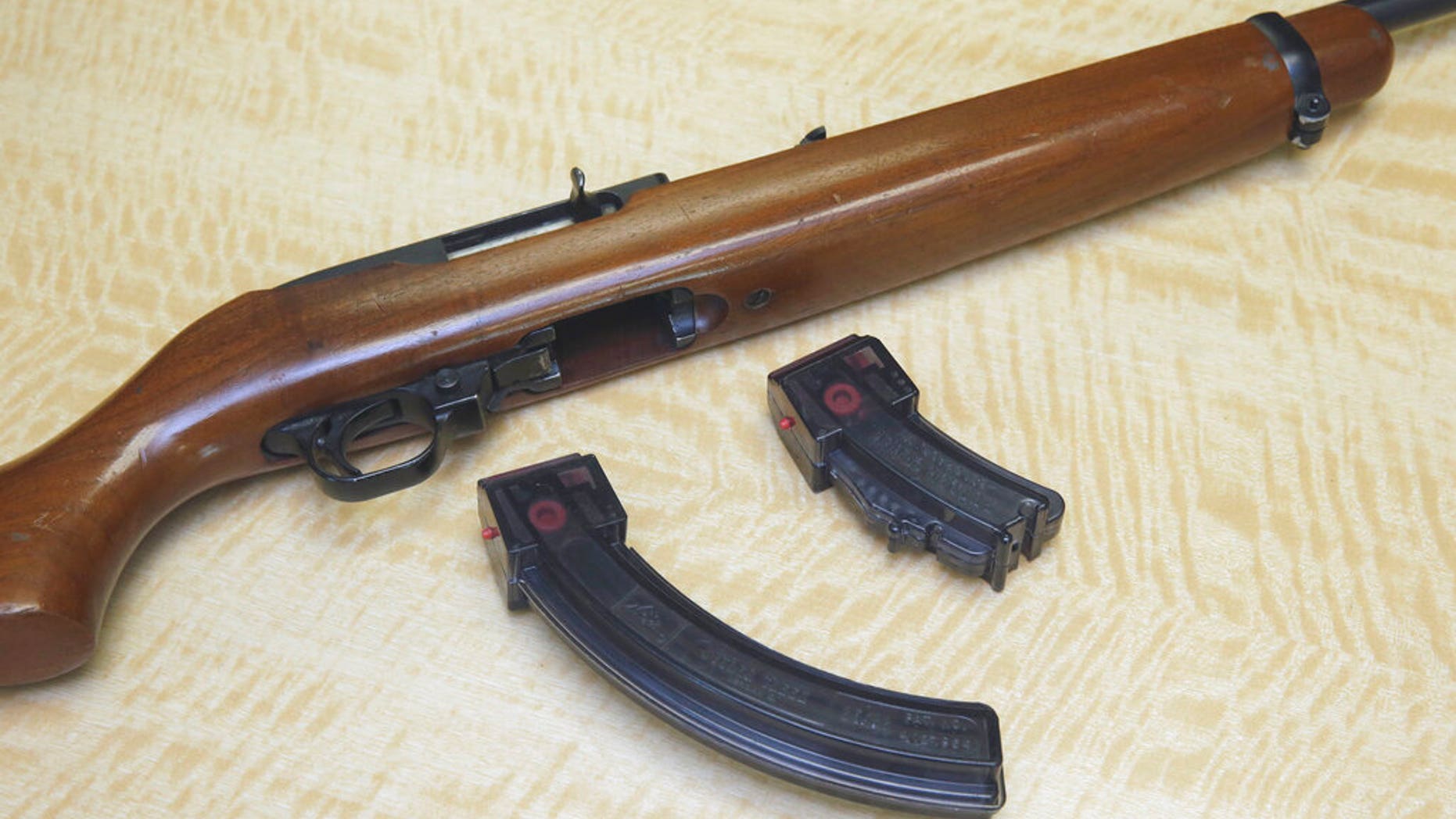 FILE: A semi-automatic rifle is displayed with a 25 shot magazine, left, and a 10 shot magazine, right, at a gun store in Elk Grove, Calif.