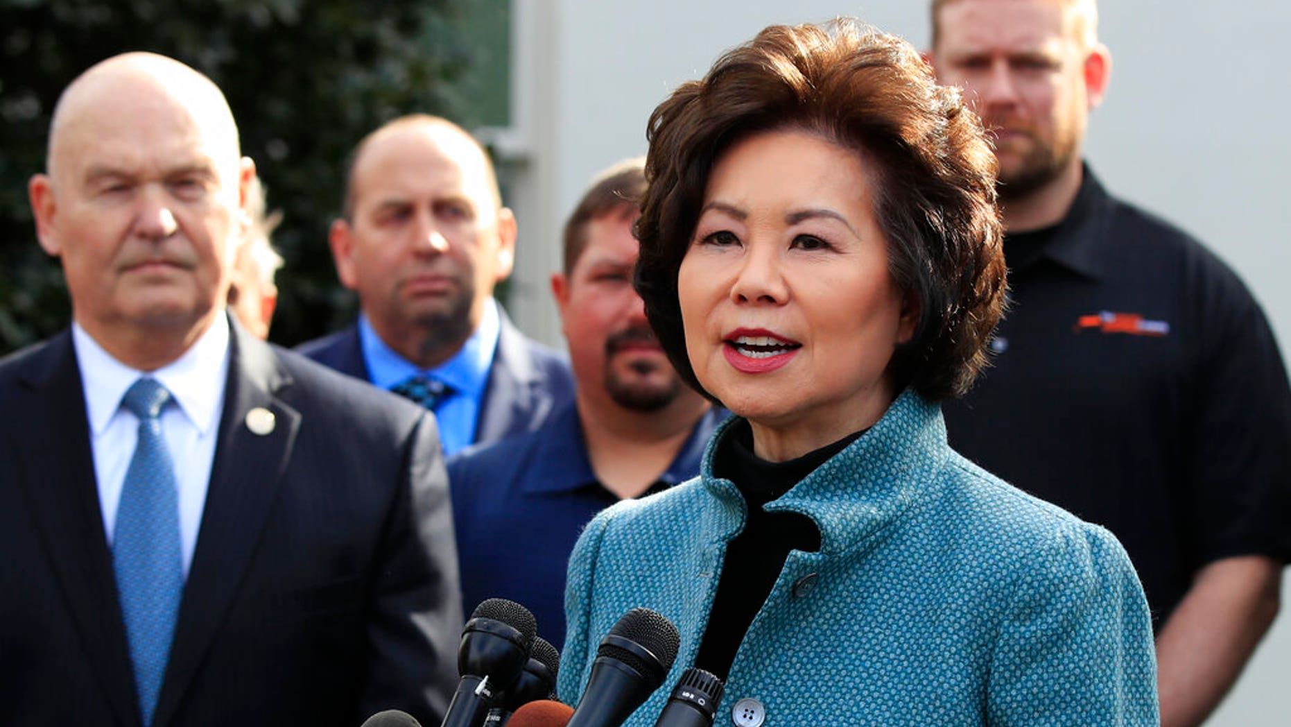 Transportation Secretary Elaine Chao, right, with U.S. Maritime Administration Administrator Mark Buzby, speaks to reporters outside the West Wing of the White House. (Associated Press)