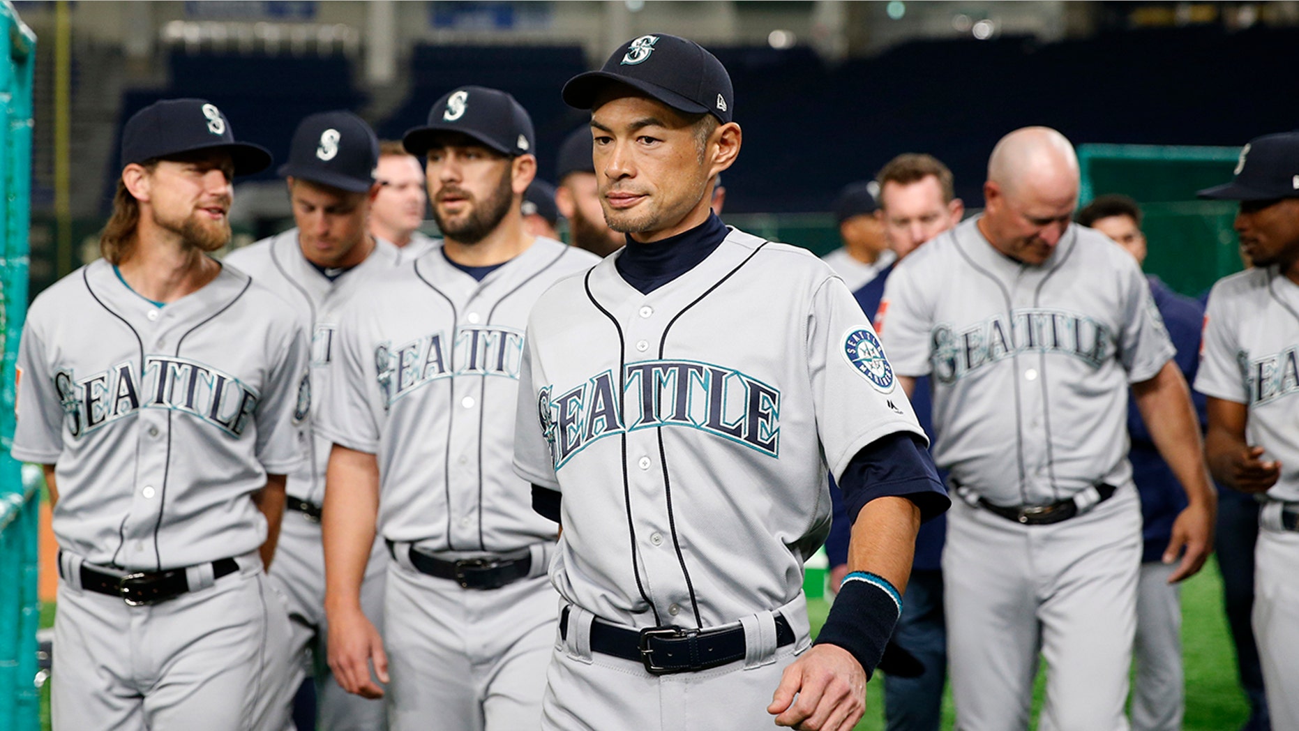 Seattle Mariners right fielder Ichiro Suzuki leaves after his team's group photo prior to Game 1 of a Major League opening series baseball game against the Oakland Athletics at Tokyo Dome in Tokyo, Wednesday, March 20, 2019.