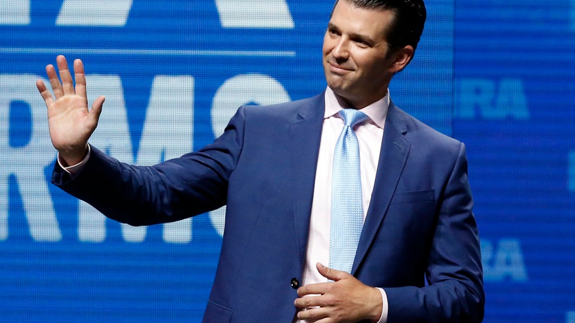 Donald Trump Jr., waves from the stage at the National Rifle Association convention in Dallas, May 4, 2018. (Associated Press)