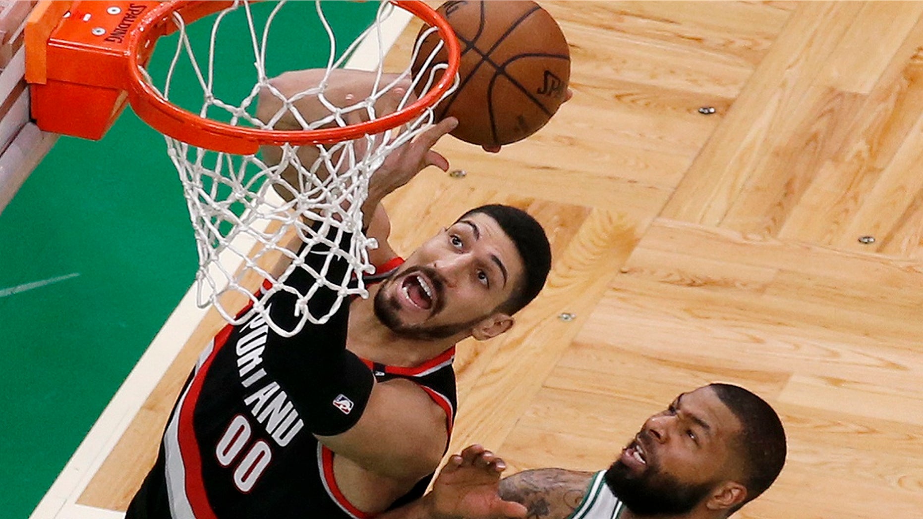 Portland Trail Blazers center Enes Kanter, left, drives to the basket against Boston Celtics forward Marcus Morris during an NBA basketball game, Feb. 27, 2019, in Boston. (Associated Press)