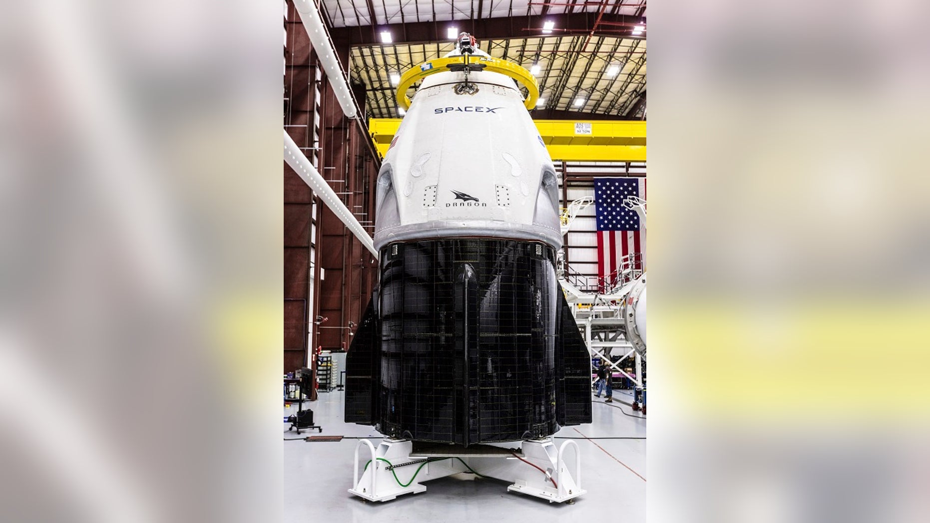 SpaceX's Crew Dragon spacecraft and Falcon 9 rocket are positioned inside the company's hangar at Launch Complex 39A at NASA's Kennedy Space Center in Florida. (Space X via AP)