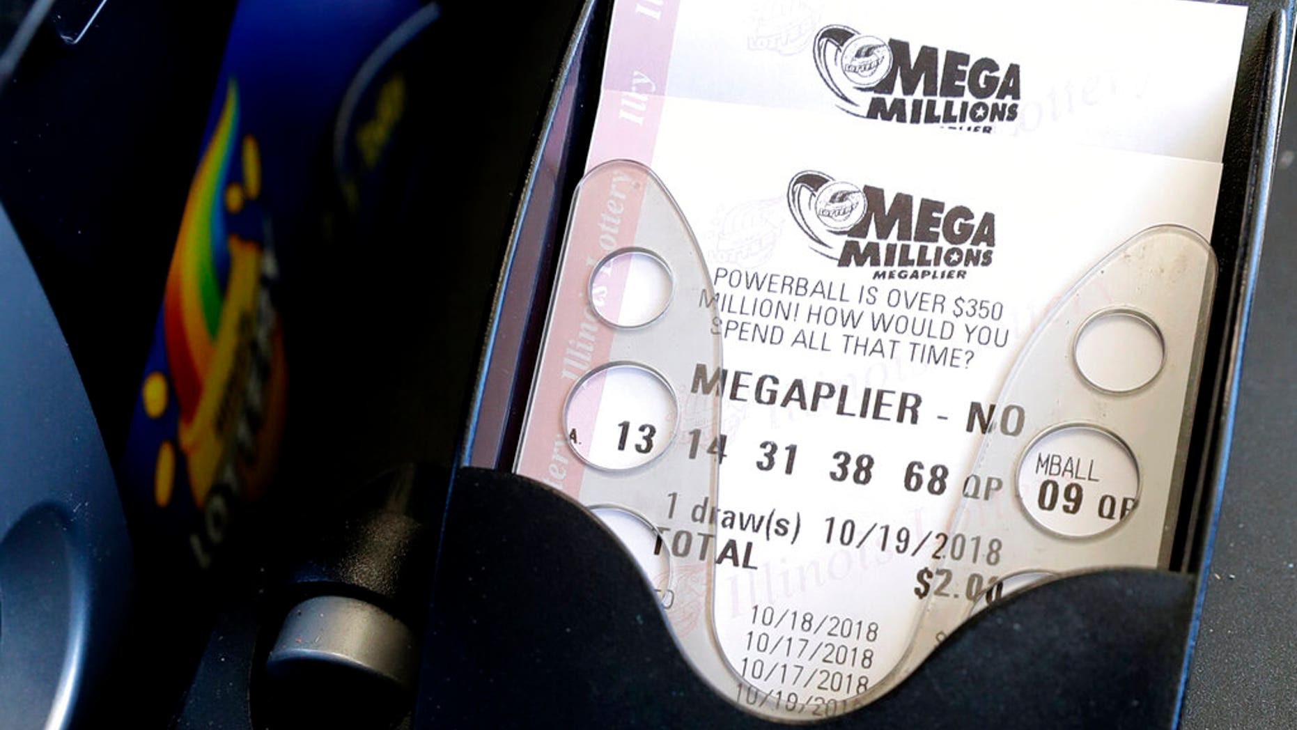 FILE: Mega Millions lottery tickets are printed out of a lottery machine at a convenience store in Chicago.