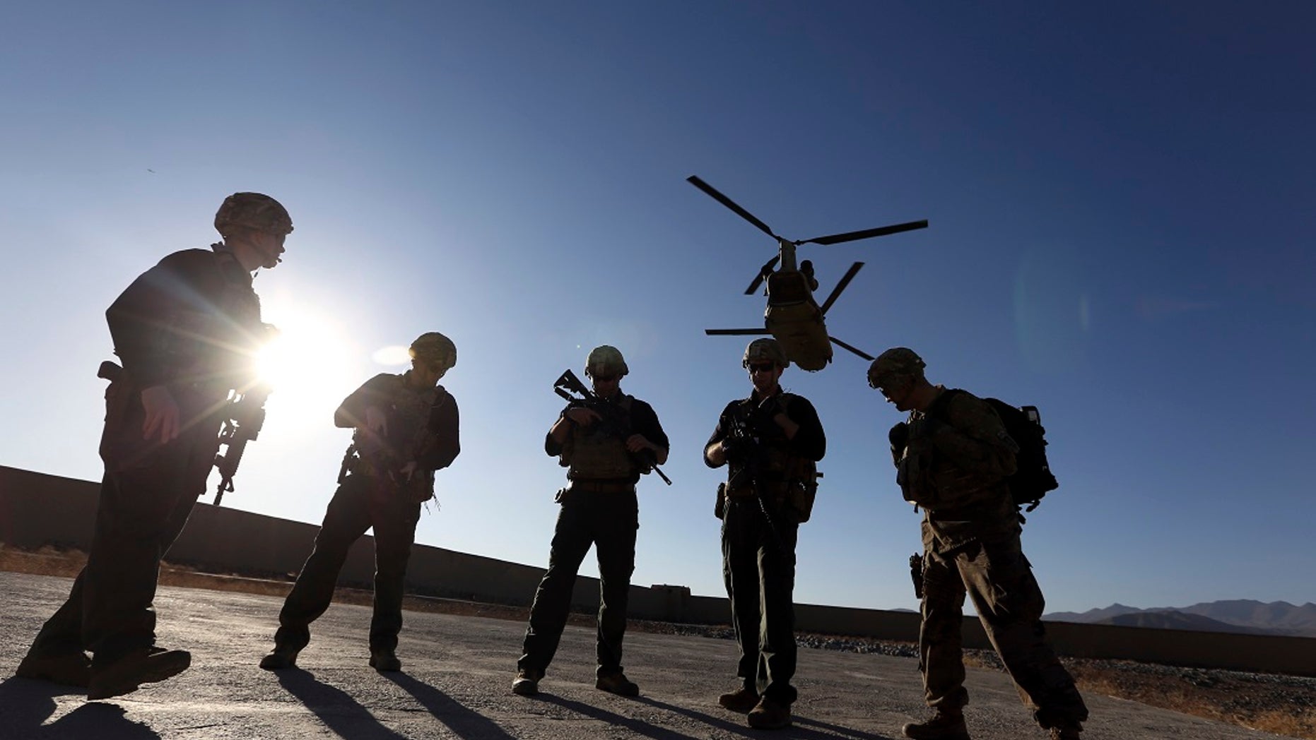 FILE - In this Nov. 30, 2017 file photo, American soldiers wait on the tarmac in Logar province, Afghanistan. Two members were killed Friday during an operation in the country. (Associated Press)