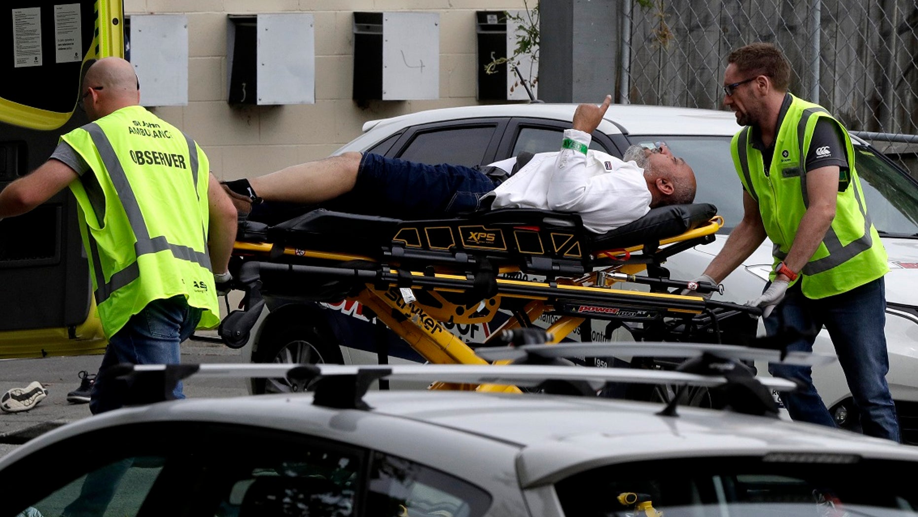 Ambulance staff take a man from outside a mosque in central Christchurch, New Zealand, Friday, March 15, 2019. A witness says many people have been killed in a mass shooting at a mosque in the New Zealand city of Christchurch.(AP Photo/Mark Baker)