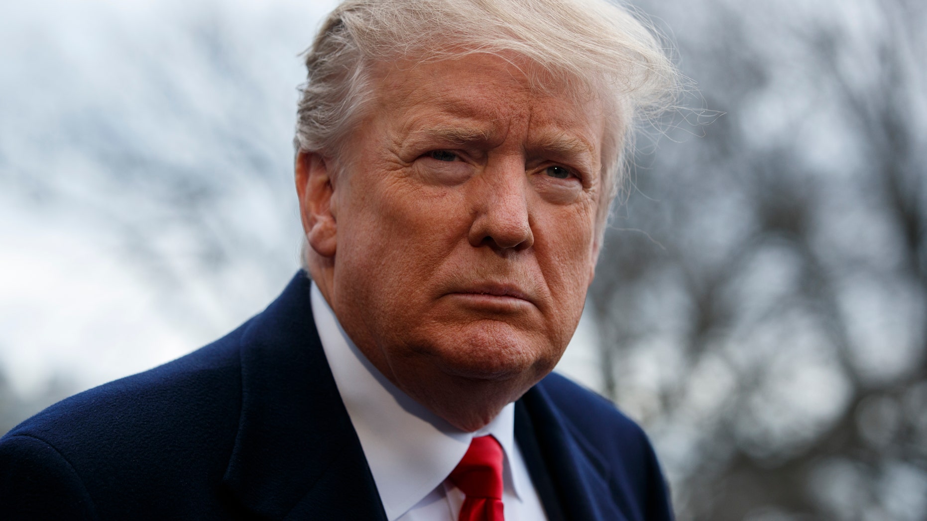 President Donald Trump listens to a question as he speaks with reporters before boarding Marine One on the South Lawn of the White House, Friday, March 22, 2019, in Washington.