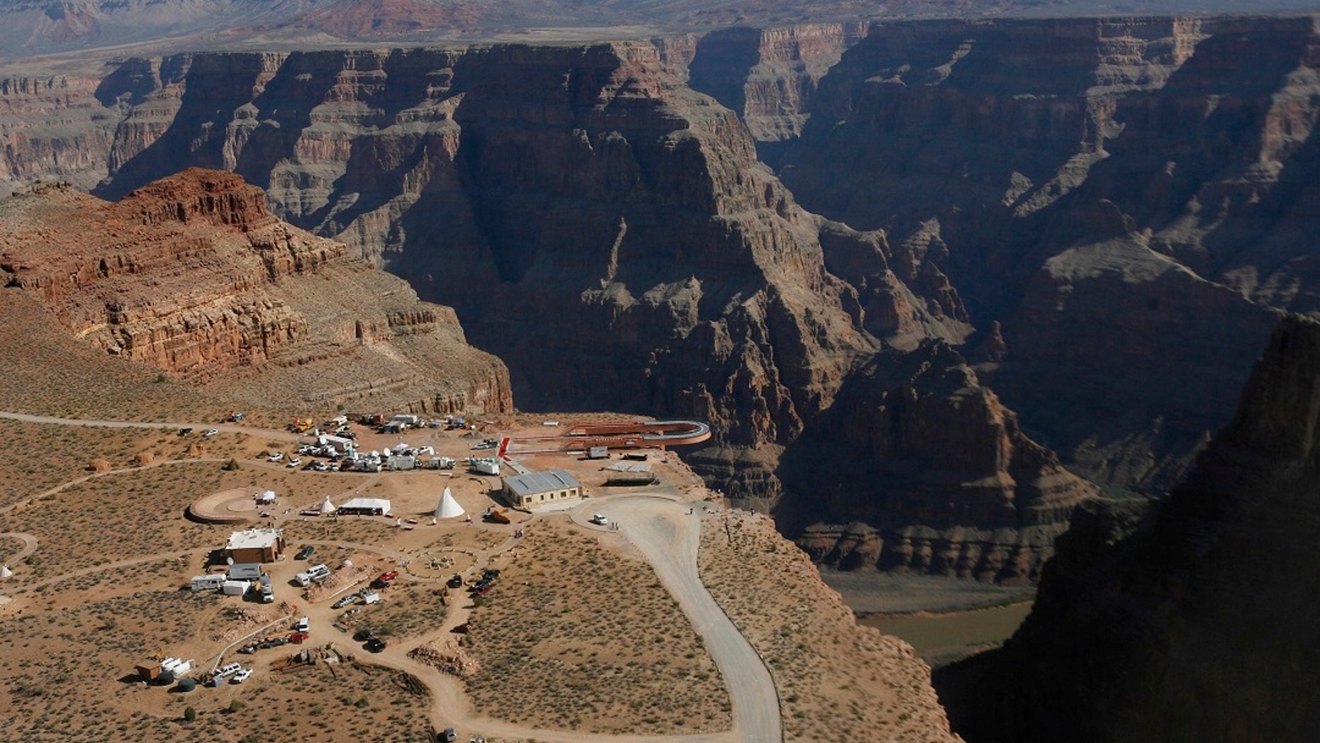 Skywalk hangs over the Grand Canyon at Hualapai Indian Reservation before its grand opening ceremony at Grand Canyon West, Ariz. Crews are looking for a tourist who slipped and fell over the edge of a Grand Canyon looking into tribal land. (AP Photo / Ross D. Franklin, File)