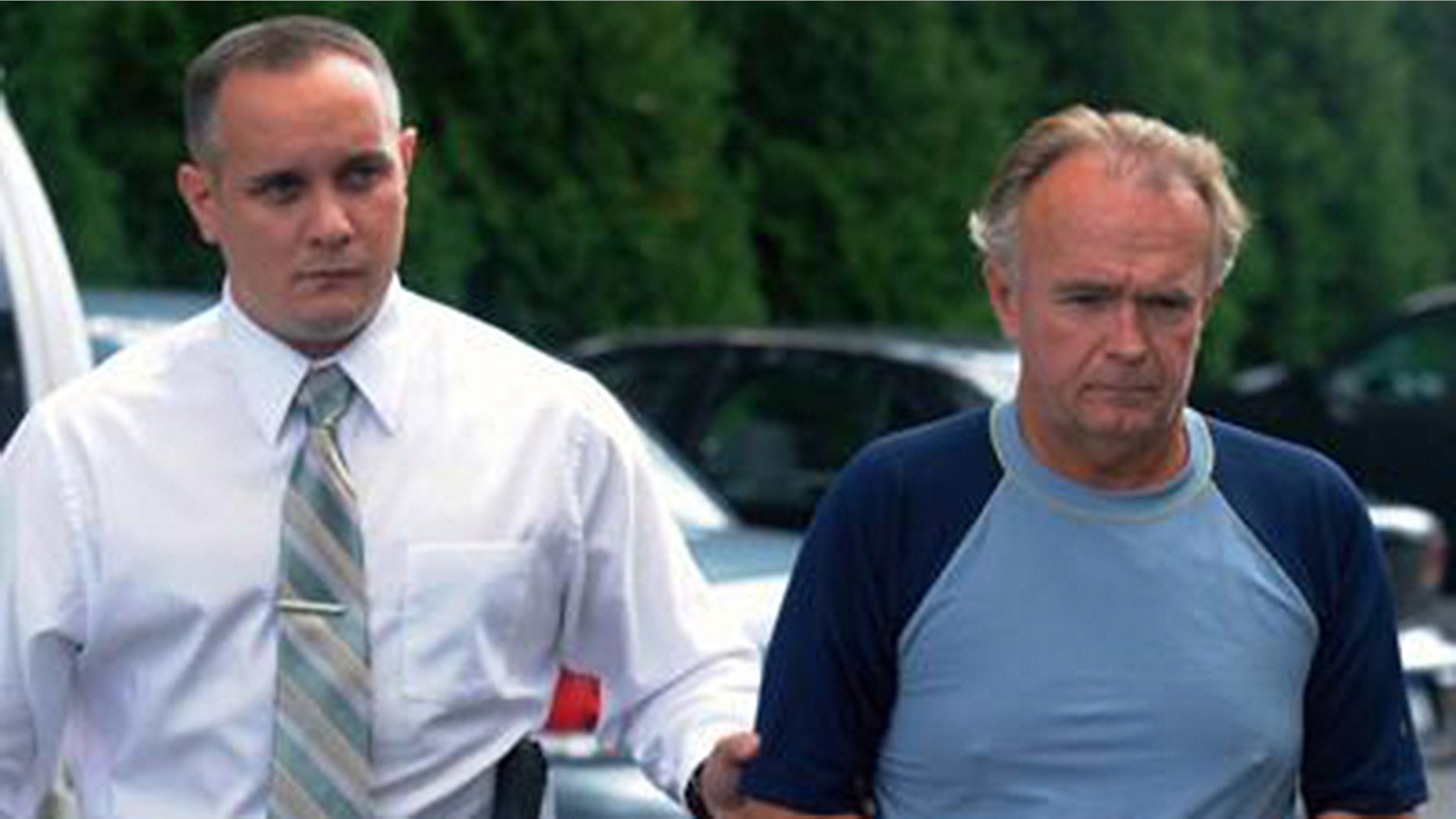 The Rev. Arthur Burton Schirmer, 62, right, is led into district court by Pennsylvania State Trooper Bill Skotleski in Tannersville, Pa., in this Sept. 13, 2010 file photo. The retired Pennsylvania pastor was ordered Tuesday, Sept. 28, 2010 to stand trial on charges he killed his wife and staged a car accident to cover it up, a case that has investigators re-examining his first wife's death. (AP Photo/Pocono Record, David Kidwell)