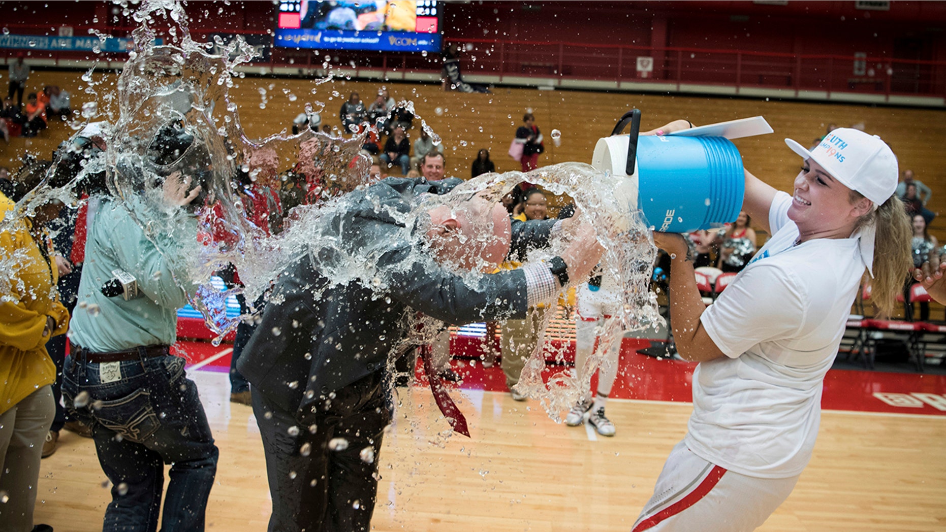 Radford forward Laney Corbin (42) douses coach Mike McQuire while celebrating after the team's win over Campbell during an NCAA college basketball game for the Big South women's tournament championship in Radford, Va., Sunday, March 17, 2019.