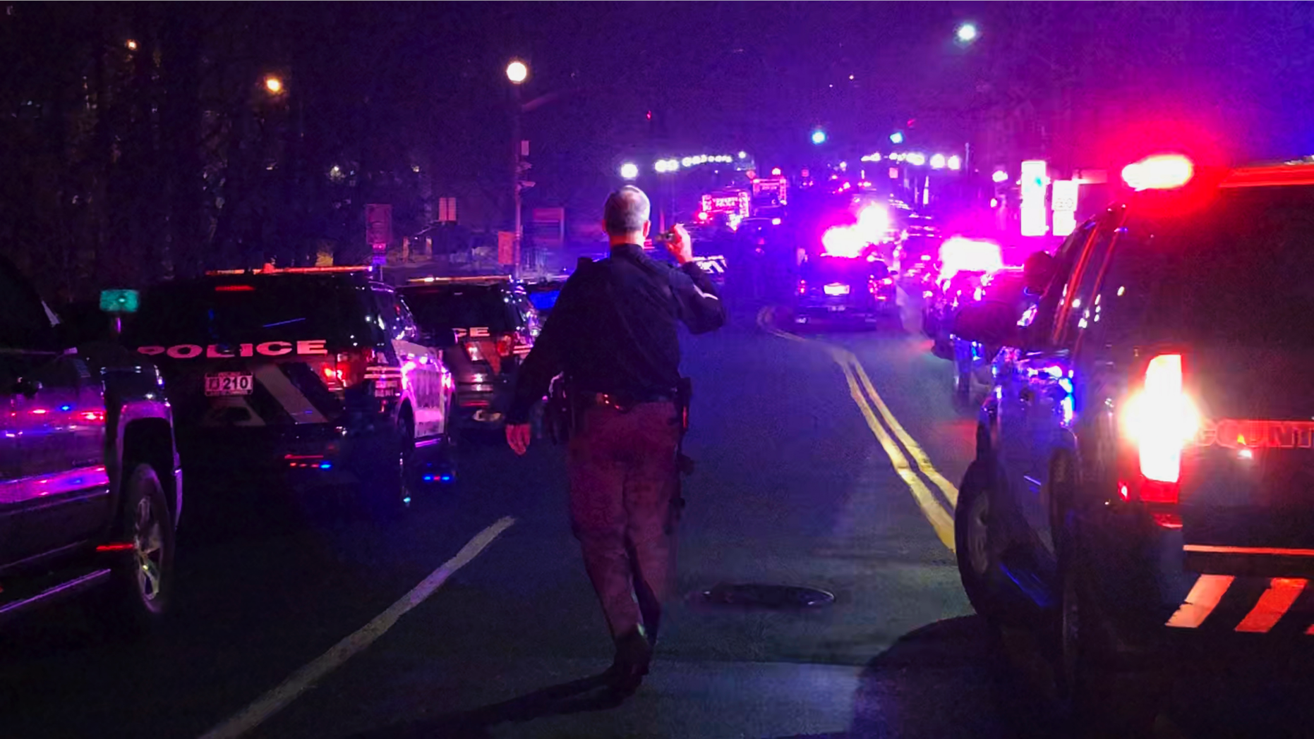 One of the first responders walk near New York-Presbyterian/Lawrence Hospital in Bronxville, N.Y., Sunday, March 10, 2019. Police are investigating a report of an armed man at the hospital north of Manhattan. (AP Photo/Luke Sheridan)