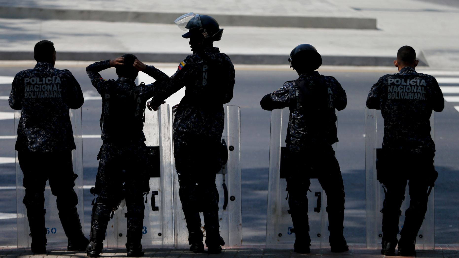 Police stand on a square in anticipation of a march called by a coalition of opposition parties and civic groups who are petitioning lawmakers for a law of guarantees that will protect workers who have been victims of political retaliation and unjustified dismissals, in Caracas, Venezuela, Tuesday, March 19, 2019. (AP Photo/Natacha Pisarenko)