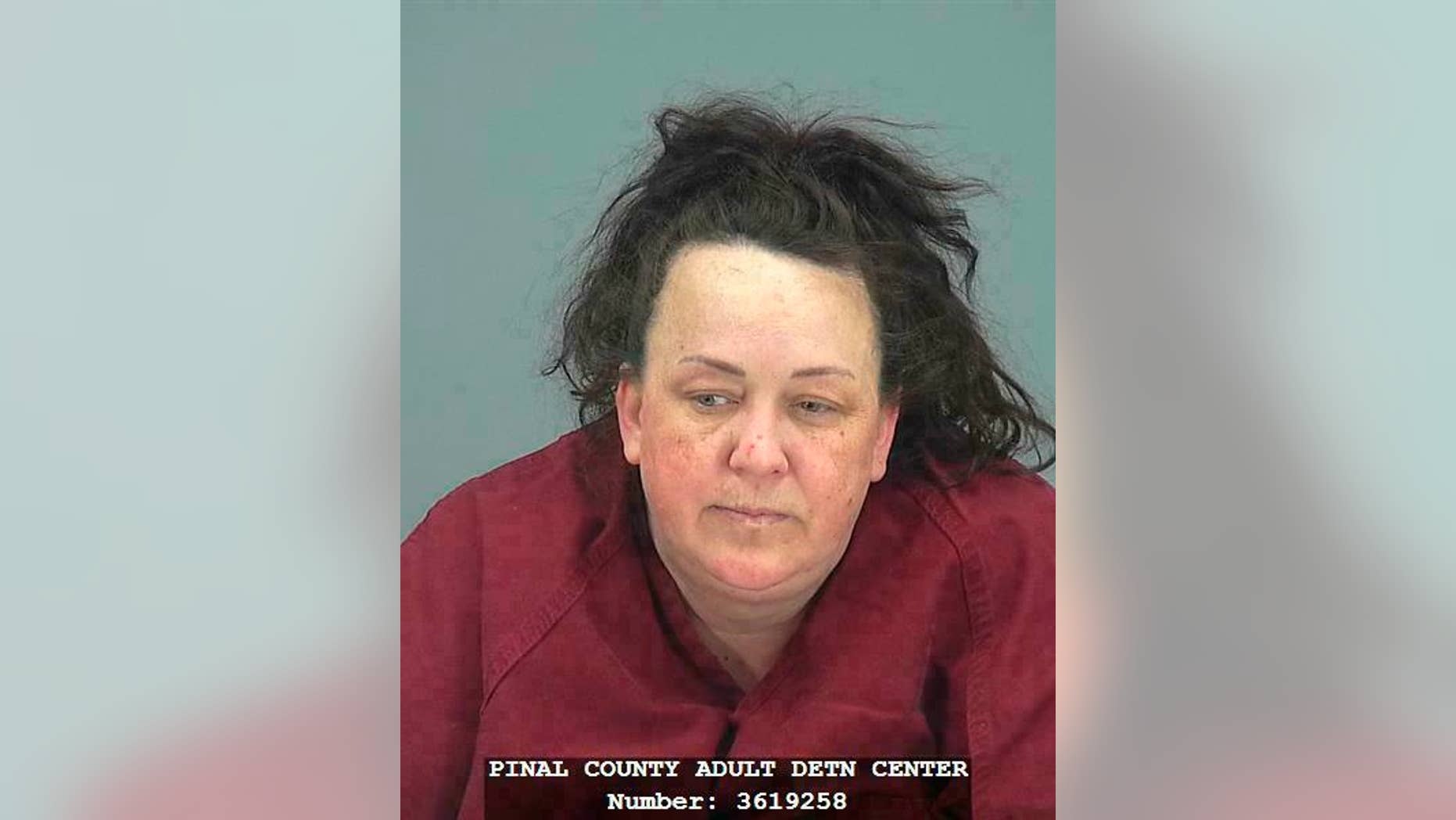 This booking photo provided by Pinal County Sheriff’s Office shows Machelle Hackney. Authorities say, Tuesday, March 19, 2019, Hackney is accused of abusing seven adopted children, including using pepper spray on them and locking them in a closet. Hackney was booked into the Pinal County Jail on suspicion of two counts of molestation of a child, seven counts of child abuse and five counts each of unlawful imprisonment and child neglect. (Pinal County Sheriff’s Office via AP)
