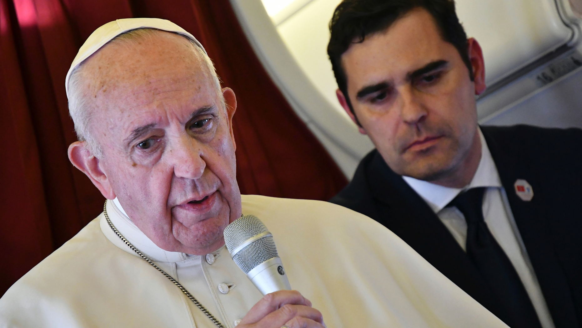 Pope Francis, flanked by interim director of Holy See Press Office, Alessandro Gisotti, speaks to reporters on board the flight back to Rome from a two-day trip to Morocco, Sunday, March 31, 2019. Francis sought Sunday to encourage greater fraternity between Christians and Muslims in Morocco, telling his flock that showing the country's Muslim majority they are part of the same human family will help stamp out extremism. (Alberto Pizzoli/Pool Photo via AP)