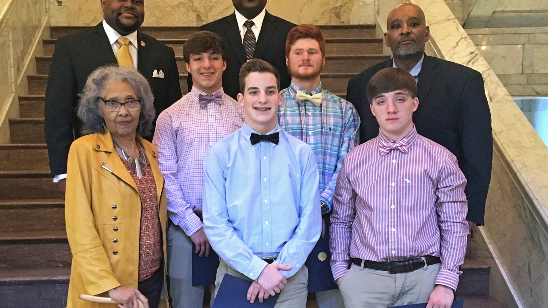 In this March 21, 2019, photograph state lawmakers honor four teenagers who helped rescue a 2-year-old girl from her mother's car as it was sinking into a creek on March 9, 2019, in Leland, Miss., following an appearance before both chambers of the Legislature at the Capitol in Jackson. On the front row are Rep. Alyce Clarke, D-Jackson, left; Austin McNemar, 15, and Seth Humphrey, 17. On the middle row are Jacob Humphrey, 17 and C.J. Holland, 18, and Rep. John Hines, D-Greenville. On the back row are Rep. Otis Anthony, D-Indianola and Riverside High School principal Donald Coleman. All four of the teenagers attend Riverside High School. (AP Photo / Emily Wagster Pettus)