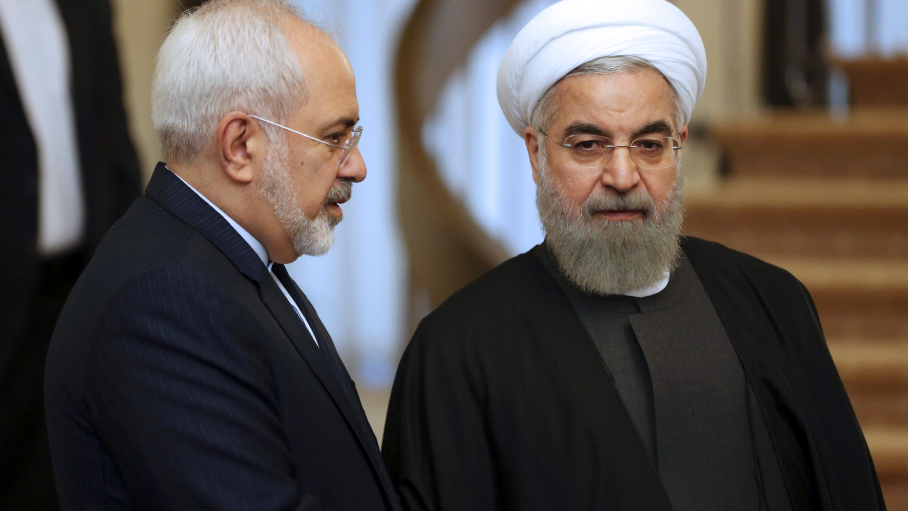 FILE - In this Nov. 24, 2015, file photo, Iranian President Hassan Rouhani, right, listens to his Foreign Minister Mohammad Javad Zarif prior to a meeting in Tehran, Iran. Rouhani is planning to make his first official visit to Iraq Monday, March 11, 2019, as he faces mounting pressure from hard-liners at home in the wake of the unravelling of the nuclear deal under the Trump administration. (AP Photo/Vahid Salemi, File)