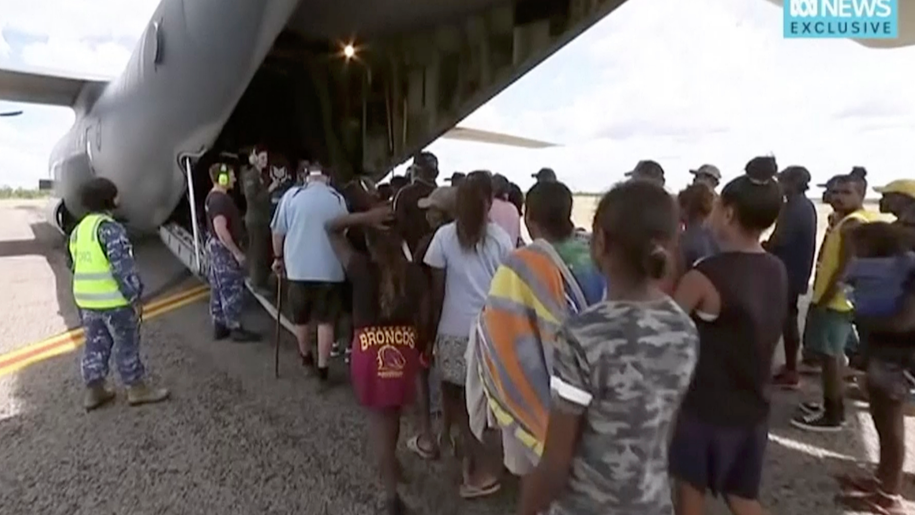 In this image made from video taken on March 21, 2019, storm evacuees board an Australian Defence Force C-130 plane preparing to take off from Borroloola, Australia. Two powerful cyclones are spinning toward Australia's sparsely populated north where around 2,000 people have been evacuated from the east coast of the Northern Territory ahead of strong winds, mountainous waves and flooding rain. (Australian Broadcasting Corporation via AP)