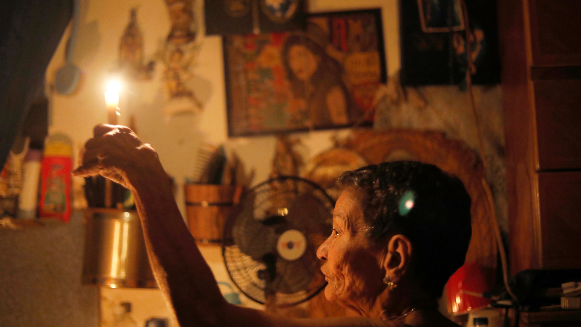 72-year-old Elizabeth Guzman Espitia holds a candle in herwindowless room she calls her “little cave” during a blackout in the Santa Cruz of the East neighborhood, in Caracas, Venezuela, Thursday, March 14, 2019. I’ve never see a crisis like this. It’s the first time,” Espitia said. “It makes me so sad.” Venezuela’s power grid crashed March 7, throwing almost all of the oil-rich nation’s 30 million residents into chaos for nearly a week. (AP Photo/Ariana Cubillos)