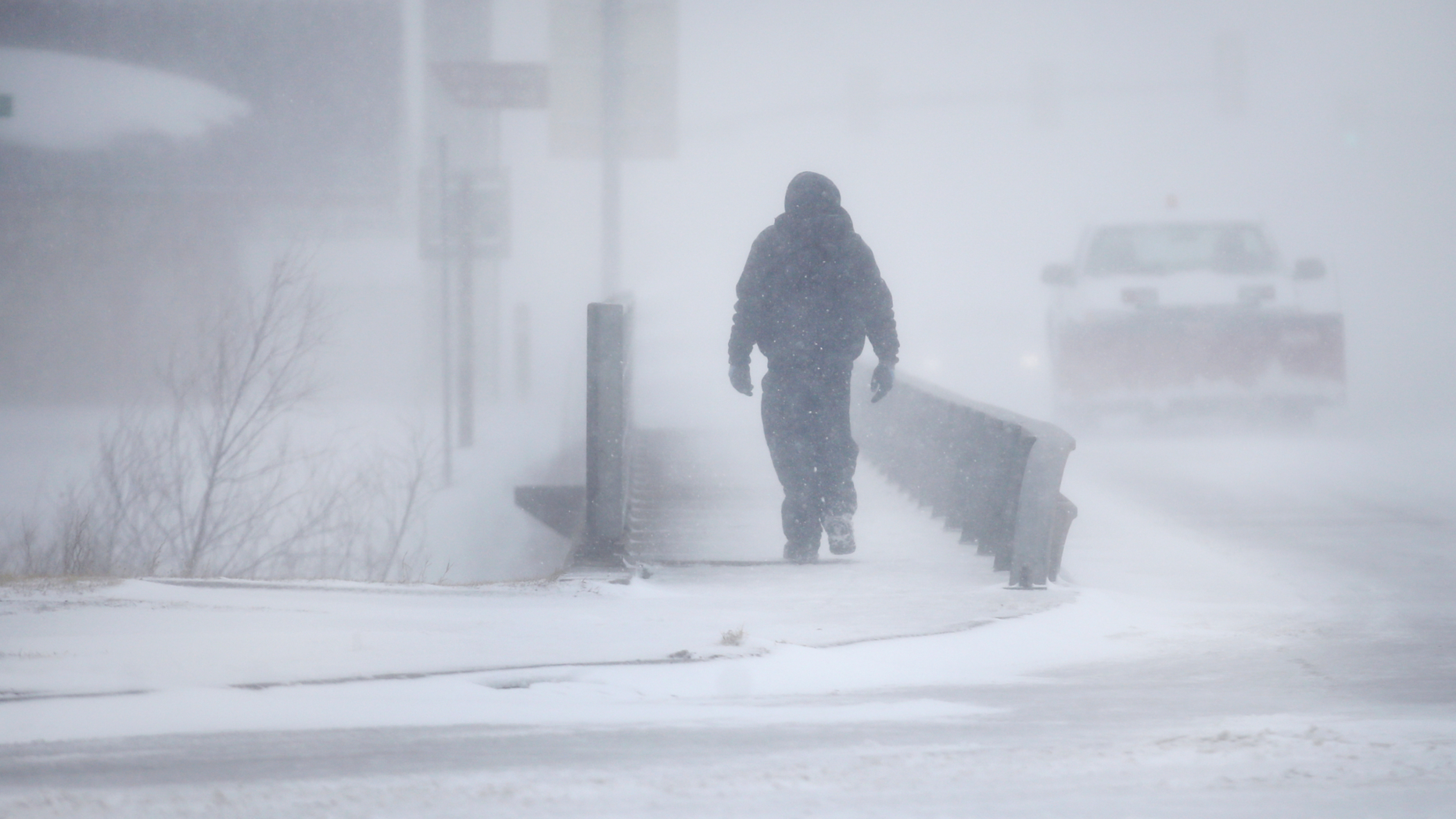 A man crosses Crow Creek during a blizzard on Wednesday, March 13, 2019, in Cheyenne, Wyo. Heavy snow hit Cheyenne about mid-morning Wednesday and was spreading into Colorado and Nebraska. (Jacob Byk/The Wyoming Tribune Eagle via AP)