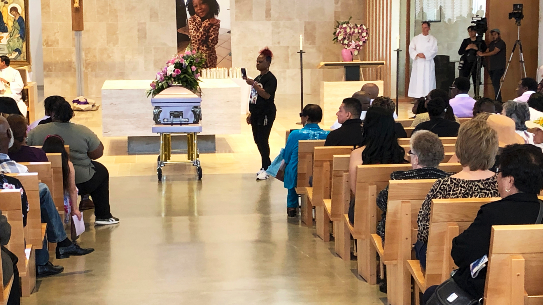 Mourners gather for the funeral service of Trinity Love Jones, the 9-year-old whose body was found this month stuffed in a duffel bag along an equestrian trail, at St. John Vianney Catholic Church in Hacienda Heights, Calif., Monday, March 25, 2019. The Hacienda Heights community where her body was found had embraced the child in death during the days she remained unidentified. A park worker found Trinity on March 5. A huge memorial sprang up at the site as community members heard about the case. She was identified the following weekend and prosecutors have since filed murder charges against her mother and the mother's boyfriend. (AP Photo/John Rogers)