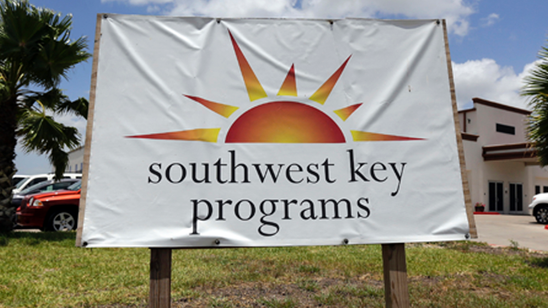 FILE - This June 20, 2014, file photo shows a Southwest Key program sign in Brownsville, Texas. Authorities in Arizona say workers who were seen on video dragging and shoving immigrant children being held at a privately run shelter won't face charges. The Maricopa County Attorney's Office said Friday, March 29, 2019 that there's no reasonable likelihood of proving the workers at a Southwest Key facility committed a crime. (AP Photo/Eric Gay, File)
