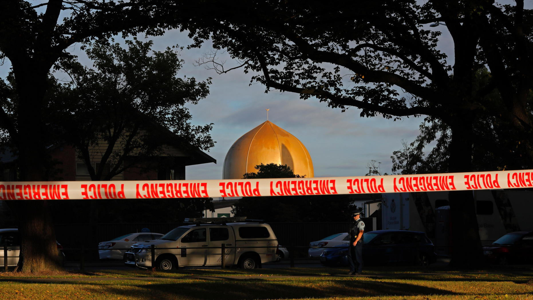 FILE - In this March 17, 2019, file photo, a police officer stands guard in front of the Masjid Al Noor mosque in Christchurch, New Zealand, where one of two mass shootings occurred. Growing certainty that a single gunman was responsible for the attacks renews attention to warnings about the threat of terror attacks by ideologically driven lone actors. But stereotypes of such attackers, often called “lone wolves” in the U.S., risks obscuring the fact that many are not as solitary as some might believe, criminologists say. (AP Photo/Vincent Yu, File)