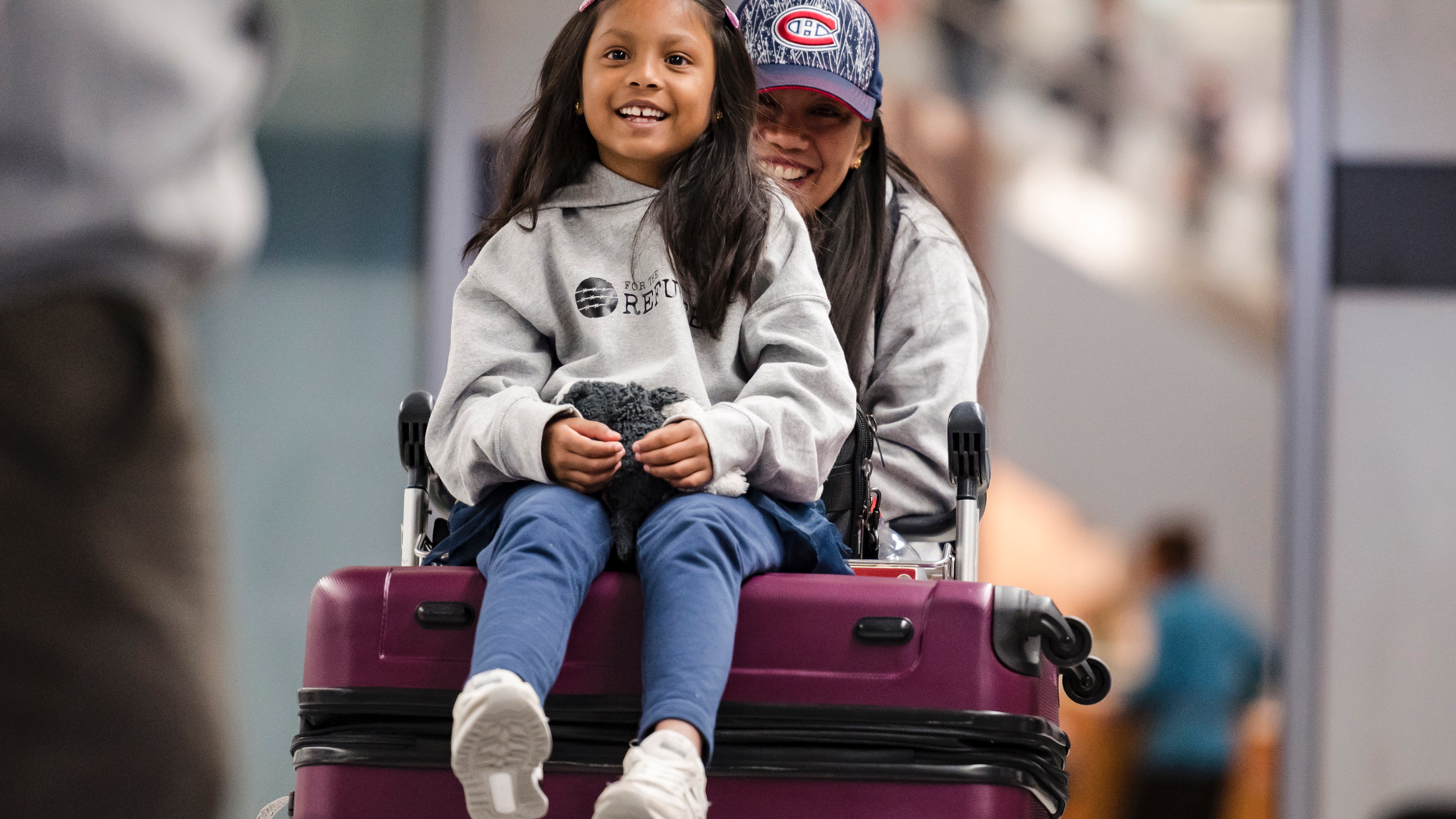 Vanessa Rodel and her 7-year-old daughter Keana exit Lester B. Pearson Airport in Toronto on Monday, March 25, 2019. The Filipino woman who helped shelter former NSA contractor Edward Snowden when he fled to Hong Kong has been granted refugee status in Canada. (Christopher Katsarov/The Canadian Press via AP)