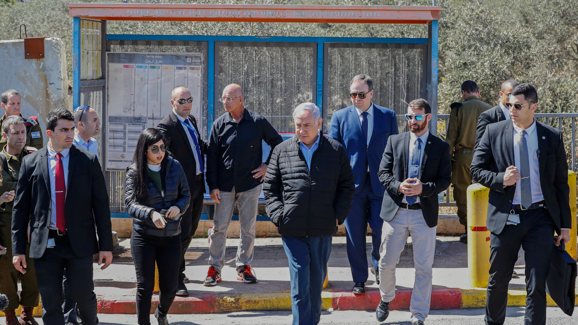 Israeli Prime Minister Benjamin Netanhayu, right, inspects the scene of a Sunday gun and knife attack, near the West Bank Israeli settlement of Ariel, Monday, March 18, 2019. Israel's military expanded its massive manhunt for a Palestinian assailant on Monday as authorities announced that a second Israeli died of wounds sustained in the West Bank attack. (Jack Guez/Pool via AP)