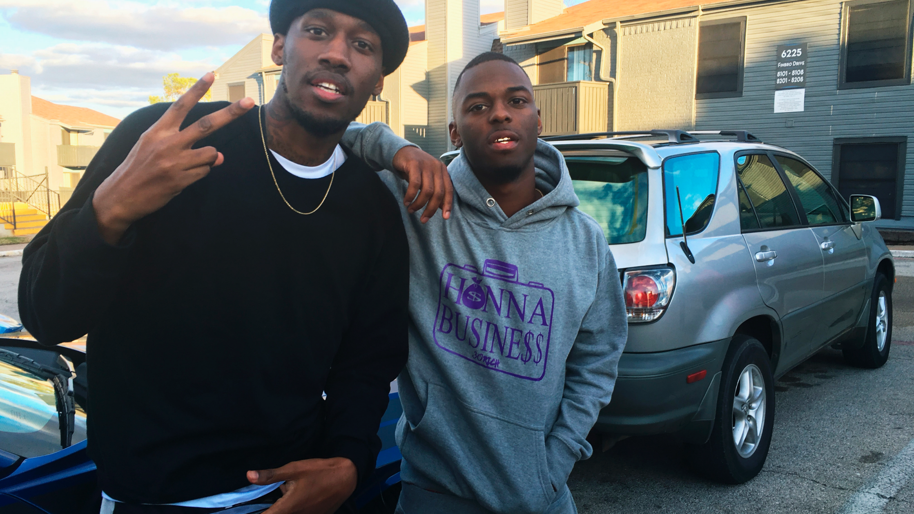 In this Dec. 27, 2018, photo, video blogger Shawn Cotton, left, poses for a portrait with rapper Wayne Walker, who performs under the stage name 30 Rich, after Cotton interviewed Walker for his YouTube channel “Say Cheese TV,” in Fort Worth, Texas. The killing of Zack Stoner, a pioneer in a new genre of news in which videographers interview street gangs and rappers in high-crime areas, has unnerved other gangland reporters nationwide, including Cotton. (AP Photo/John L. Mone)