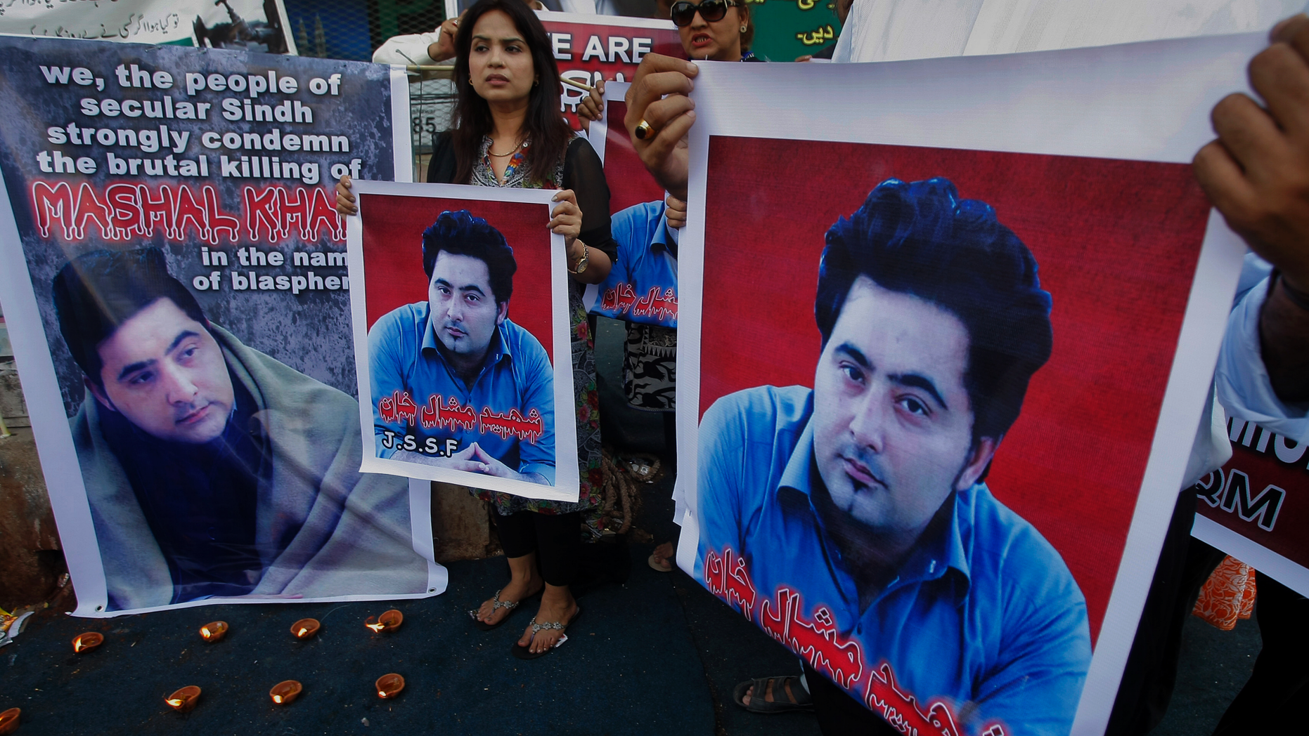 FILE - In this April 22, 2017 file photo, members of a Pakistani civil society group demonstrate against the killing of university student Mashal Khan, in Karachi, Pakistan. A court in northwest Pakistan sentenced two men to life in prison after they were found guilty of involvement in the death of Khan, a university student who was beaten and eventually shot to death by a mob after he was falsely accused of blasphemy. (AP Photo/Fareed Khan, File)