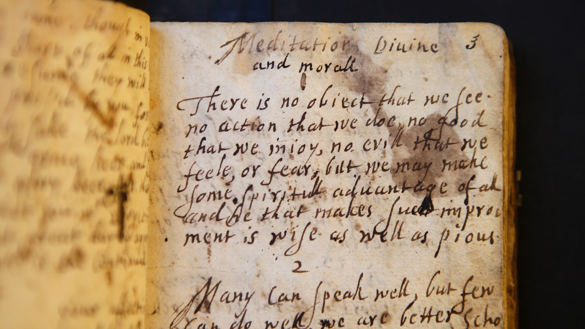 In this Wednesday, March 20, 2019, photo provided by the Board of Trustees of Stevens Memorial Library, a handwritten manuscript called "Meditations Divine and Moral," by 17th century poet Anne Bradstreet, rests on a table at the Houghton Library on the campus of Harvard University, in Cambridge, Mass. Bradstreet was the North American continent's first published poet. Her actual burial place is not known. (Courtesy of Board of Trustees of Stevens Memorial Library via AP)