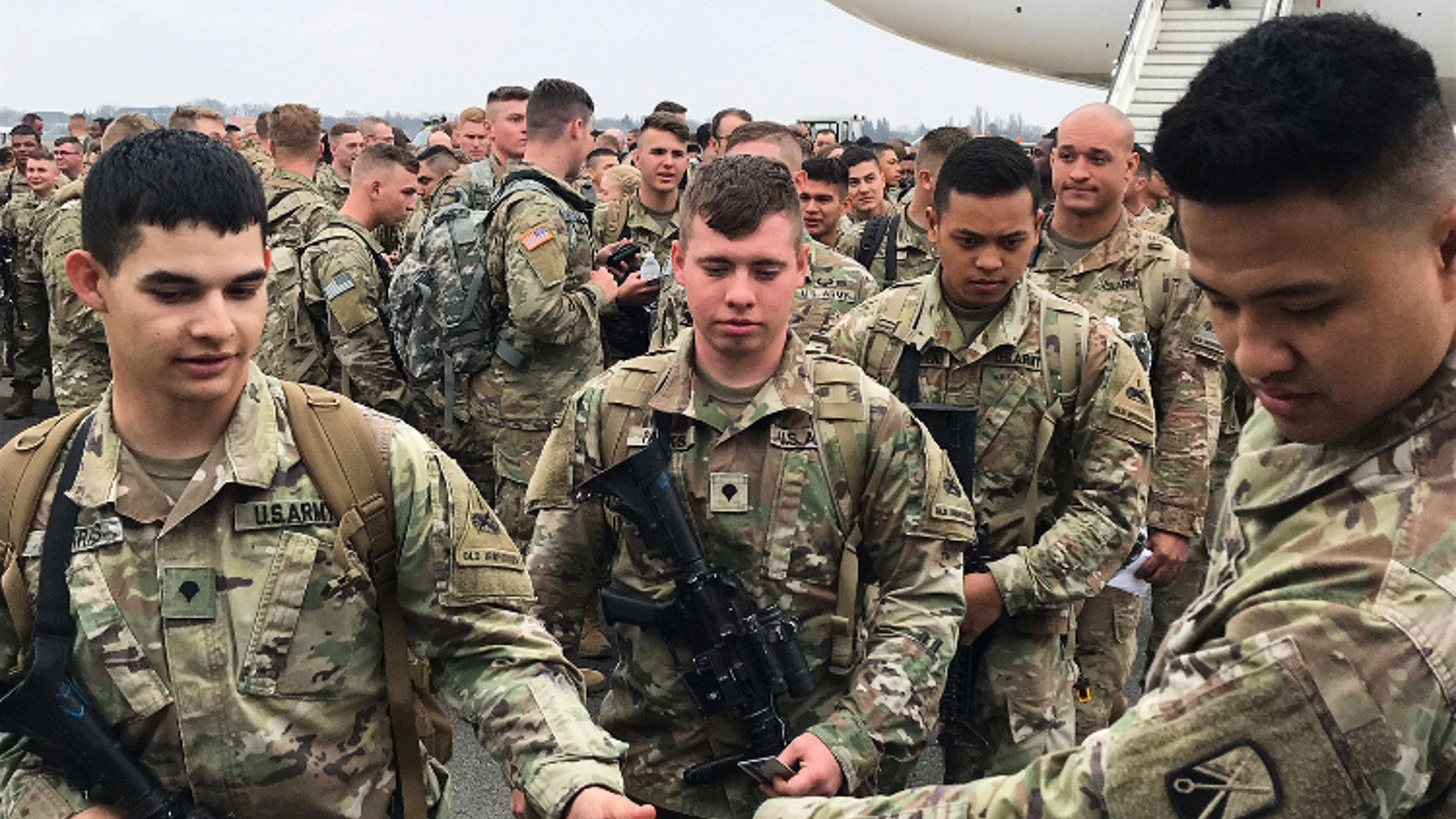 Soldiers from the 1st Armored Division, based in Fort Bliss, Texas, arrives at the airport Tegel in Berlin, Thursday, March 21, 2019. Over three hundred soldiers have arrived in Germany from their base in Texas in the first test of a new American strategy to rapidly deploy troops based in the United States to Europe to bolster the NATO deterrent against possible Russian aggression. (AP Photo/Dorothee Thiesing)