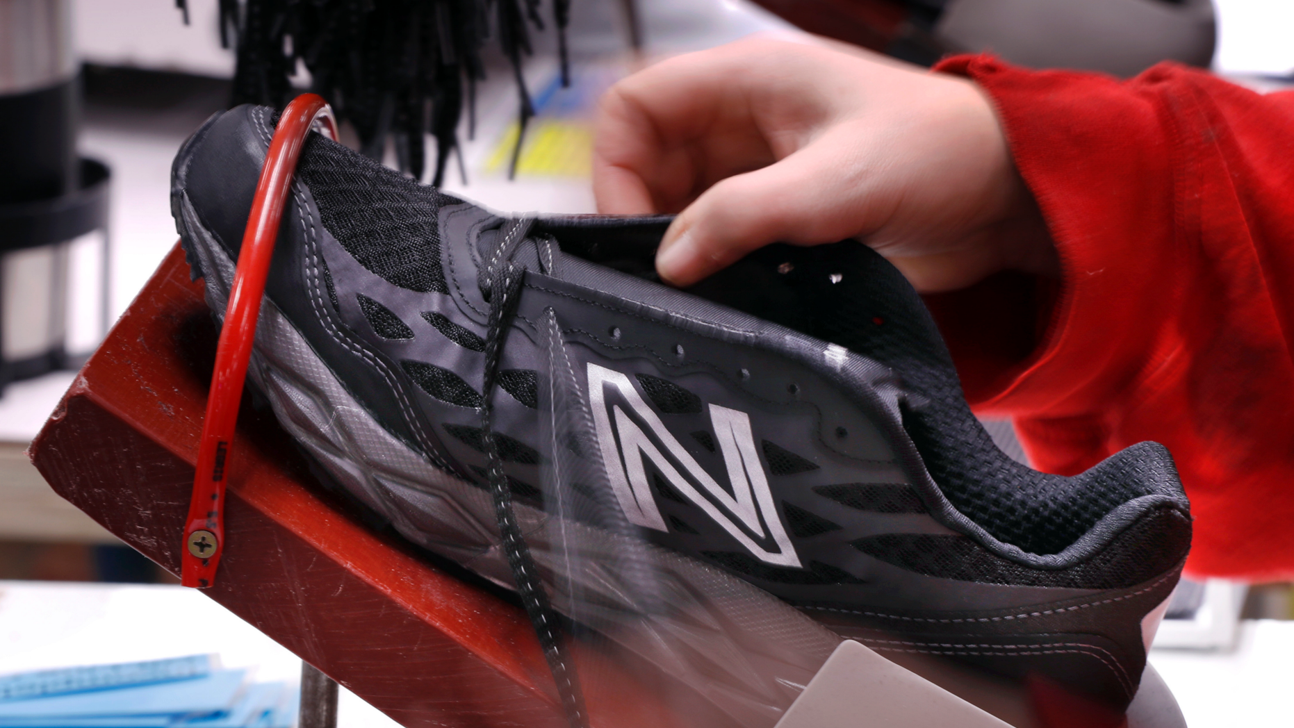 FILE- In this Dec. 17, 2018, file photo, a pair of athletic shoes designed for the military are laced up at a New Balance factory in Norridgewock, Maine. On Friday, March 1, 2019, the Institute for Supply Management, a trade group of purchasing managers, issues its index of manufacturing activity for February. (AP Photo/Robert F. Bukaty, File)