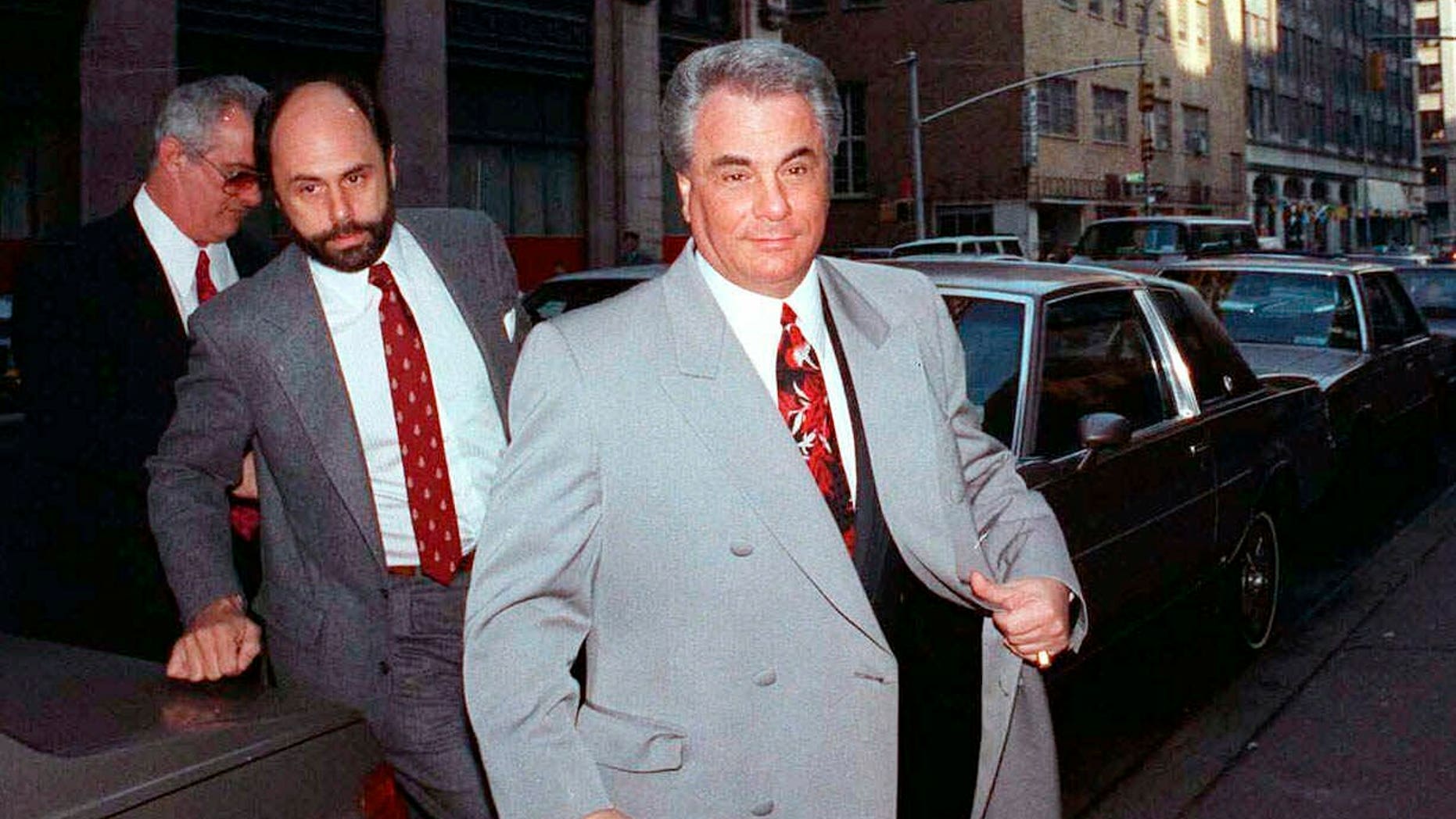 FILE - In this Feb. 9, 1990 file photo, John Gotti, right, arrives at court in New York. The Gambino family was once among the most powerful criminal organizations in the U.S., but federal prosecutions in the 1980s and 1990s sent Gotti and other top leaders to prison, diminishing its reach. The last Mafia boss to be shot to death in New York City was Gambino don Paul Castellano, assassinated outside a Manhattan steakhouse in 1985 at the direction of Gotti, who then took over the organization. On Wednesday, March 13, 2019, Francesco "Franky Boy" Cali, the reputed boss of New York's Gambino crime family was gunned down outside his home, dying a virtual unknown compared with his swaggering 1980s-era predecessor, the custom-tailored tabloid regular Gotti. (AP Photo/David Cantor, File)
