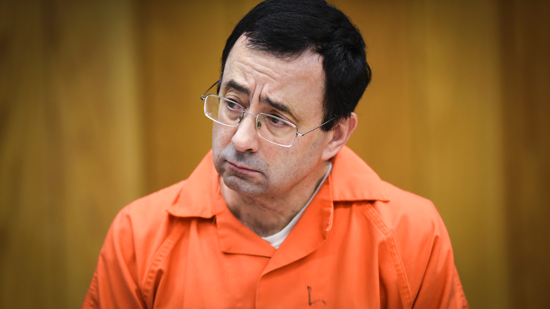 FILE - In this Feb. 2, 2018, file photo, Larry Nassar listens as Melissa Alexander Vigogne gives her victim statement in Eaton County Circuit Court in Charlotte, Mich. Fifty-one women are suing the U.S. Olympic Committee, its board members and a number of former high-ranking officials for failing to prevent their abuse at the hands of imprisoned sports doctor Larry Nassar. The lawsuit, filed Tuesday, March 12, 2019, in federal court in Denver, details abuse dating to the late 1990s. (Matthew Dae Smith/Lansing State Journal via AP, File)