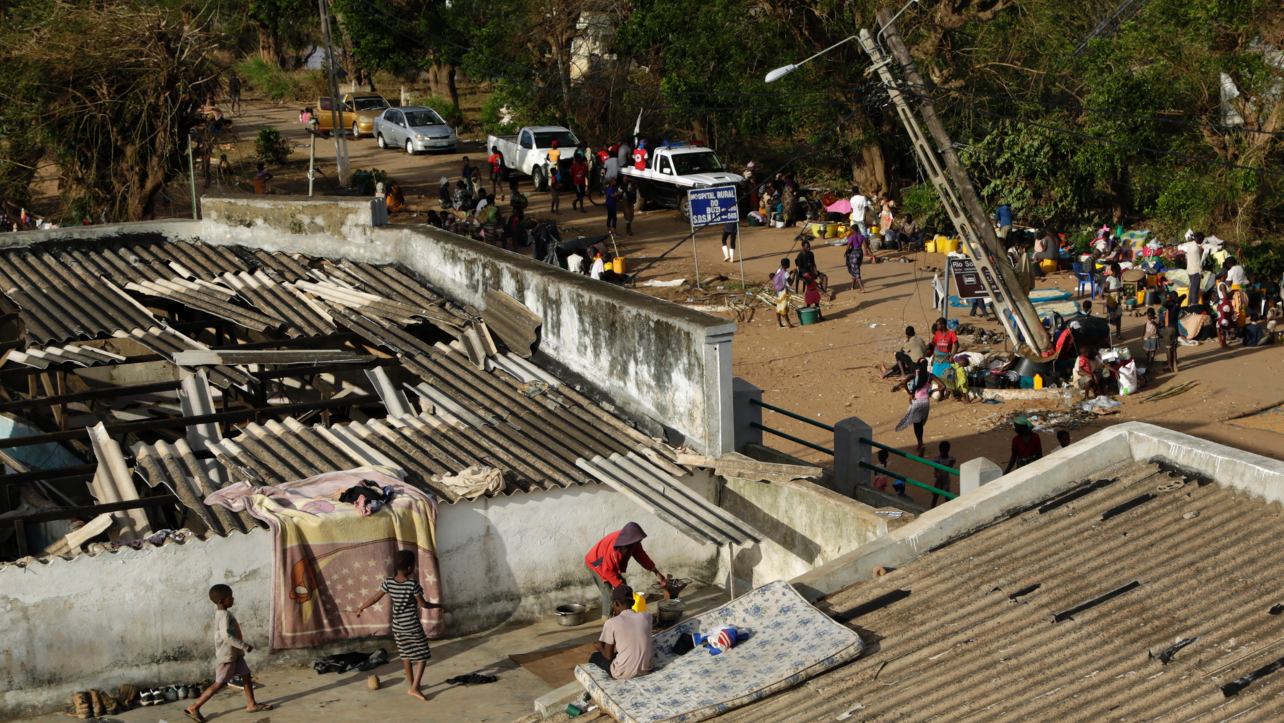 Displaced families set up their bedding on top of the roof in Buzi district, 200 kilometers (120 miles) outside Beira, Mozambique, on Saturday, March 23, 2019. A second week has begun with efforts to find and help some tens of thousands of people in devastated parts of southern Africa, with some hundreds dead and an unknown number of people still missing. (AP Photo/Themba Hadebe)