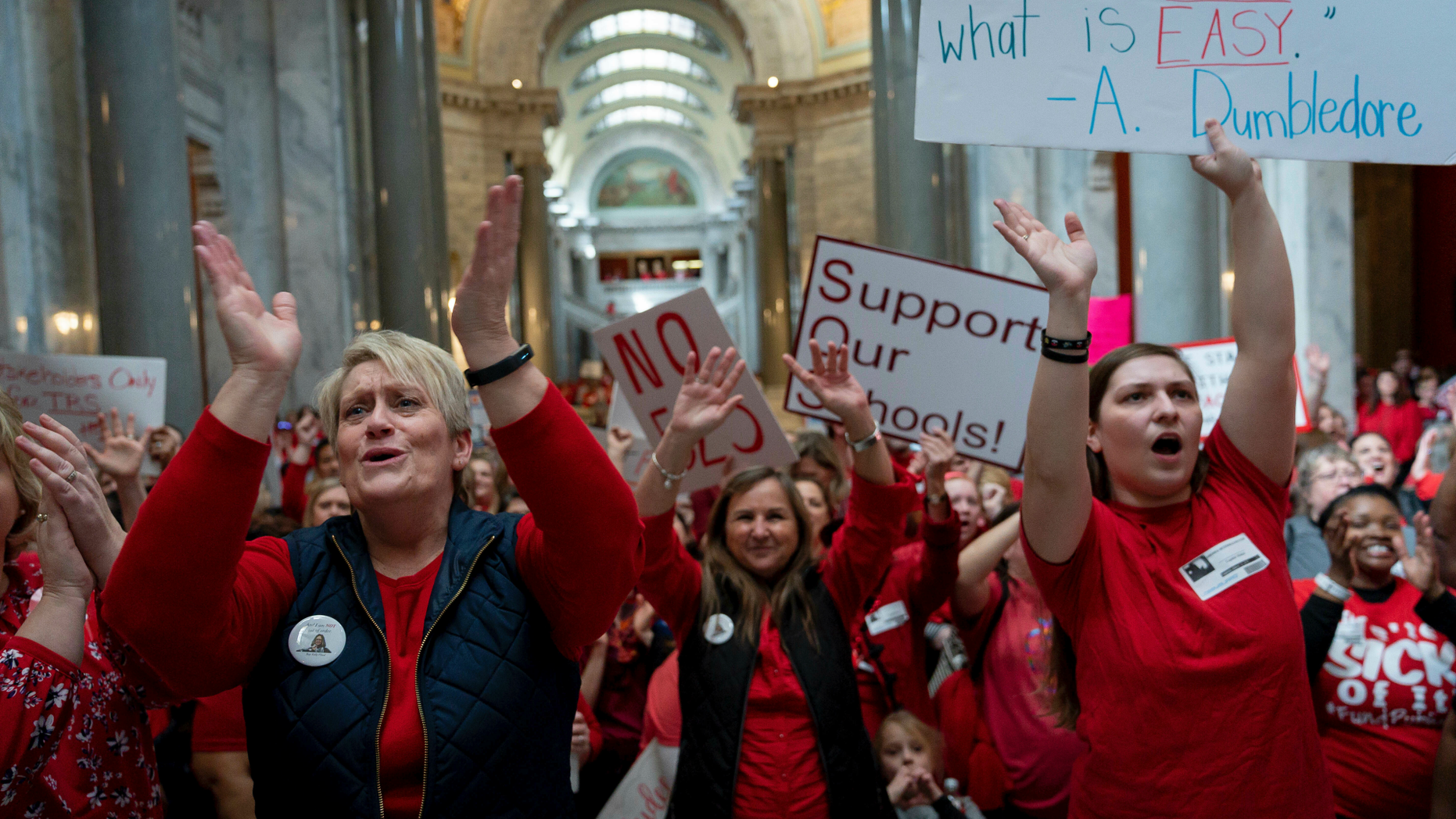 A group of the several hundred teachers gathered to protest perceived attacks on public education at the Capitol, in Frankfort, Ky, Tuesday, March 12, 2019. (AP Photo/Bryan Woolston)