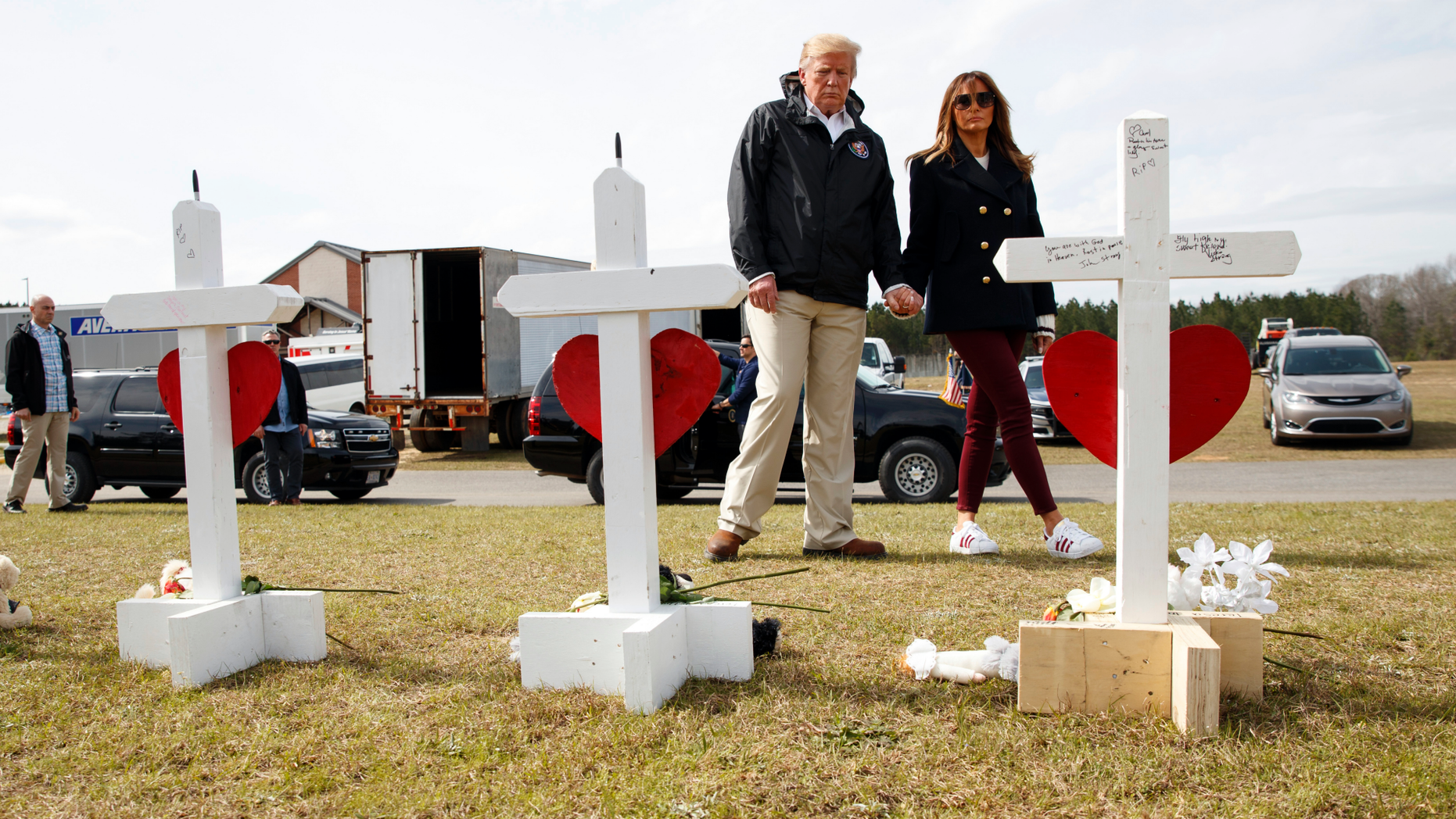 President Donald Trump and first lady Melania Trump visit crosses at Providence Baptist Church in Smiths Station, Ala., Friday, March 8, 2019, as they travel to tour areas where tornados killed 23 people in Lee County, Ala. (AP Photo/Carolyn Kaster)