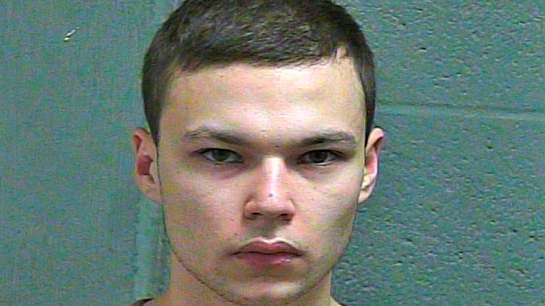 FILE--This March 4, 2019 booking photo released by the Oklahoma County Sheriff's Office shows Michael Elijah Walker. Police say the 19-year-old Oklahoma man told his younger brother that he fatally shot their parents because they were communicating with him telepathically and were Satan worshippers. Walker has pleaded not guilty to first-degree murder in his parents deaths and his attorney Derek Chance says he will seek to have Eli Walker declared mentally incompetent. (Oklahoma County Sheriff's Office via AP)