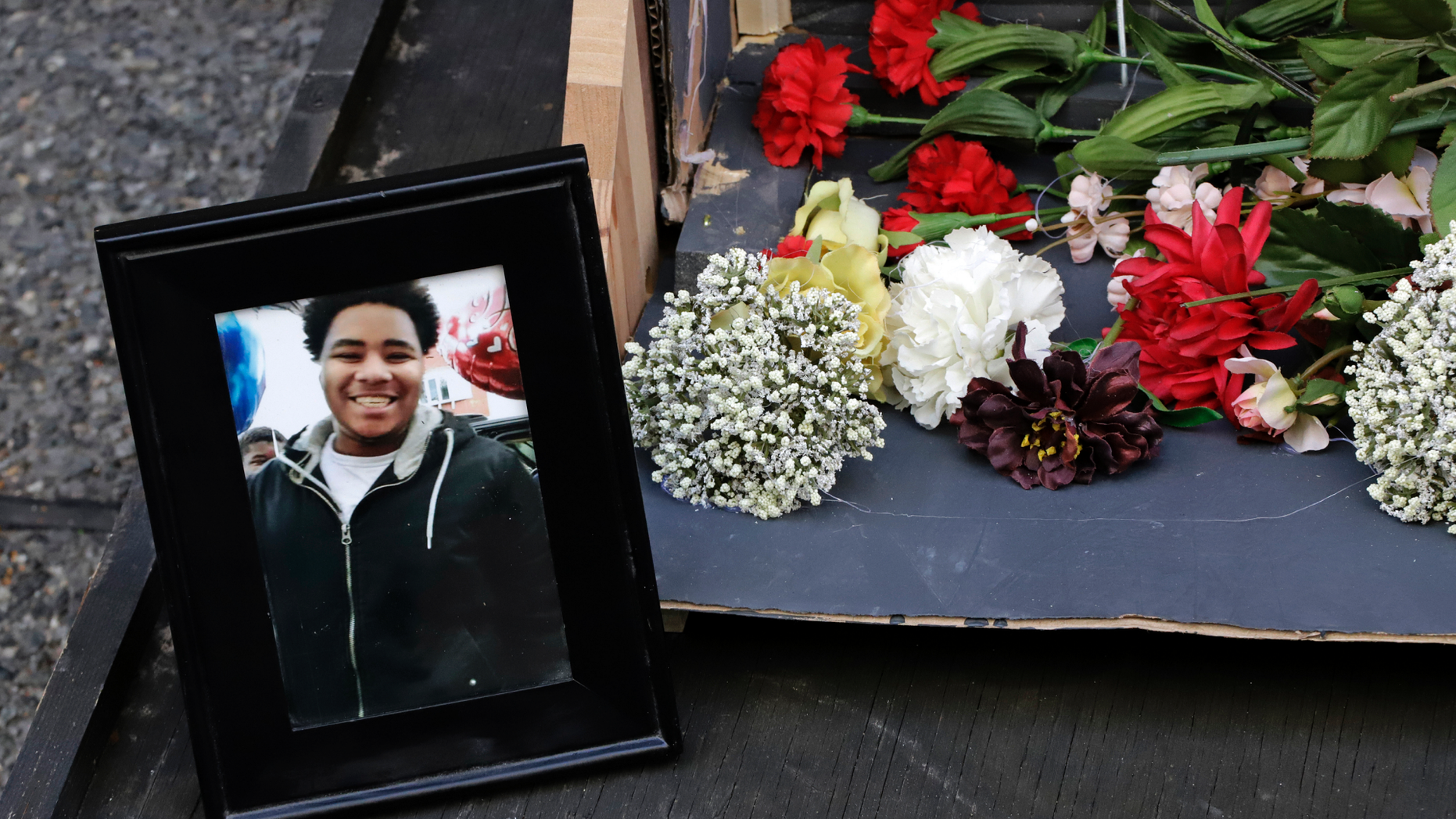 A photo of Antwon Rose II sits with a memorial display for Rose II in front of the Allegheny County courthouse on the second day of the trial for Michael Rosfeld, a former police officer in East Pittsburgh, Pa., Wednesday, March 20, 2019. Rosfeld is charged with homicide in the fatal shooting of Antwon Rose II as he fled during a traffic stop on June 19, 2018. (AP Photo/Gene J. Puskar)