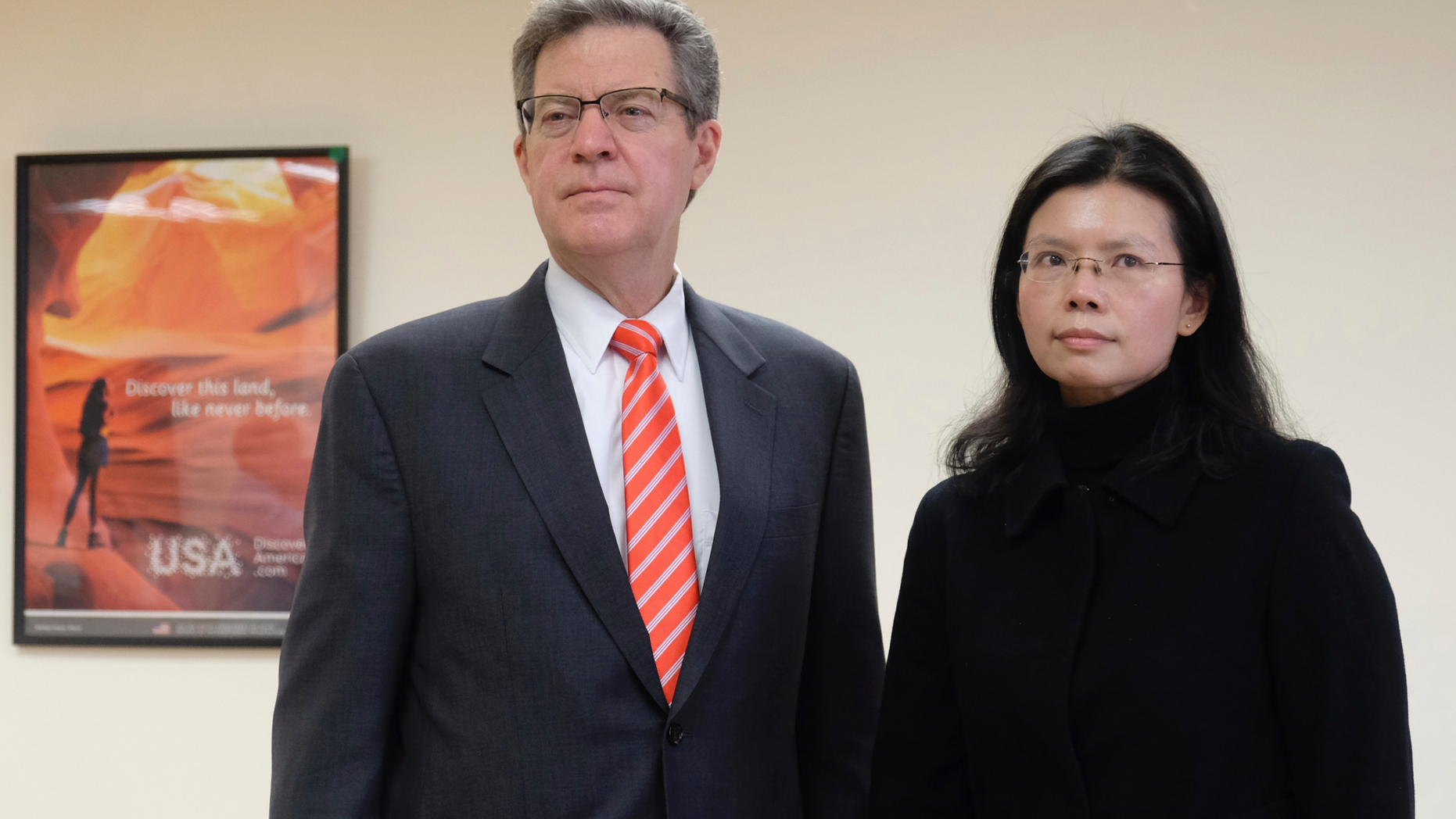 Sam Brownback, U.S. ambassador-at-large for international religious freedom, left, stands with Lee Ching-yu, the wife of Taiwanese pro-democracy activist Lee Ming-che in Taipei, Taiwan, Tuesday, March 12, 2019. Describing China's internment of an estimated 1 million Muslims as a "horrific situation," a U.S. envoy on religion called Tuesday for an independent investigation into the detentions and for the release of those being held. (AP Photo/Johnson Lai)