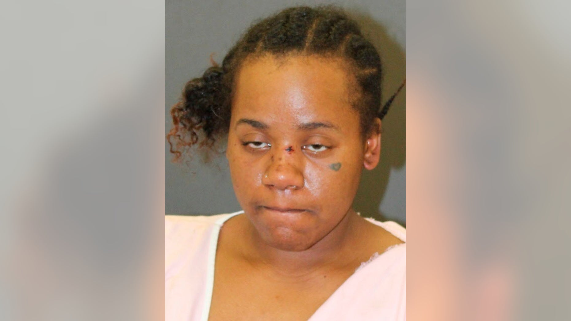 This photo provided by Baltimore Police shows Nichole George, charged in the shooting of an 11-year-old boy and his mother at a Baltimore playground. Baltimore police said in a Friday, March 15, 2019 release that 31-year-old Nichole George has been charged with attempted first-degree murder, assault and handgun violations in connection with the Wednesday evening shooting. (Baltimore Police via AP)