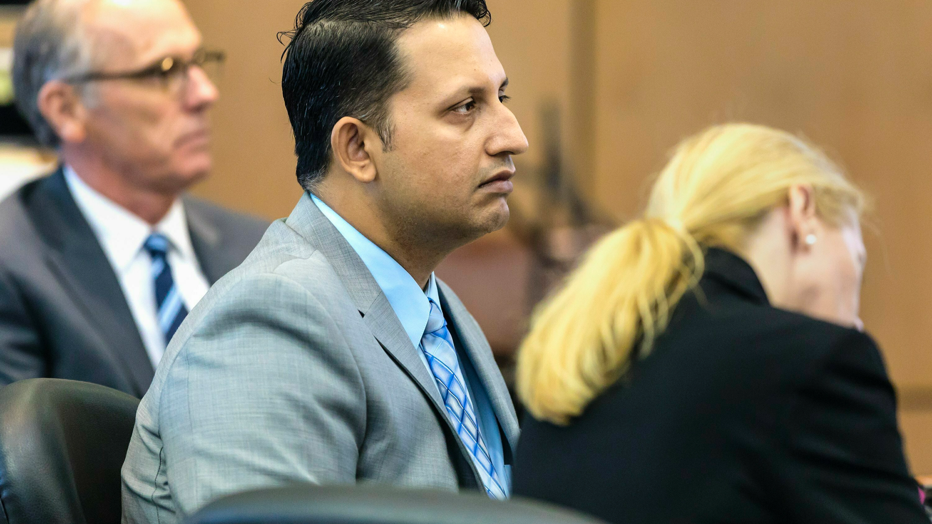 Nouman Raja sits between defense attorney Scott Richardson, left, and paralegal Debi Stratton as attorney Richard Lubin gives his closing arguments in Raja's trial, Wednesday, March 6, 2019 in West Palm Beach, Fla. Raja, a former Palm Beach Gardens police officer, is charged with the fatal 2015 shooting of stranded motorist Corey Jones. (Lannis Waters/Palm Beach Post via AP, Pool)