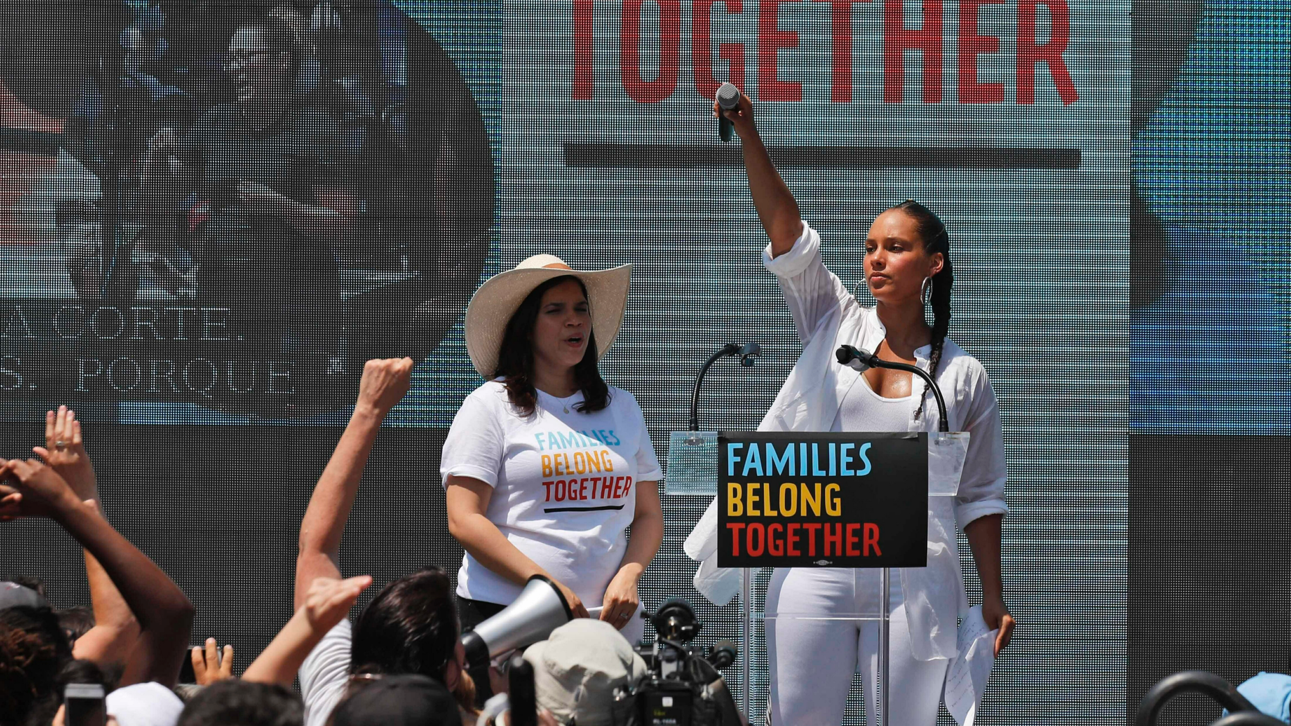 FILE - In this June 30, 2018 file photo, America Ferrera, left, with Alicia Keys, attends a protest against the Trump administration's approach to illegal border crossings and separation of children from immigrant parents in Lafayette Square across from the White House in Washington. After paying a weekend visit to Central Americans stuck on the Mexican side of the border with the United States, Ferrera said Sunday, March 10, 2019, that she was enjoying first-time motherhood last June when images of migrant children being separated from their parents by U.S. officials began to emerge. She has led a small group of like-minded artists on a visit to migrants waiting in the Mexican border city of Tijuana for a chance to apply for asylum in the U.S. (AP Photo/Alex Brandon, File)